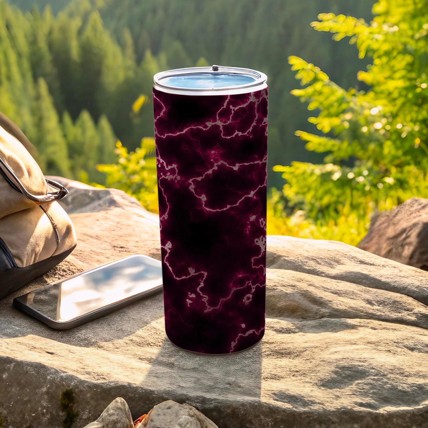 Tumbler with marble-like dark purple and black pattern on a rock.