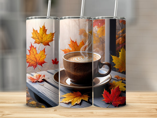 Three tumblers decorated with autumn leaves and a steaming coffee cup.