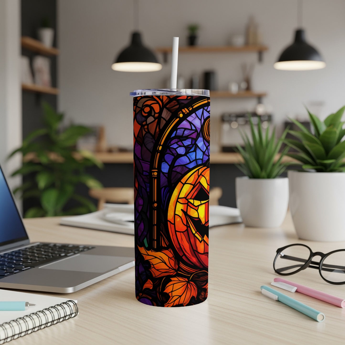 Stained glass tumbler with a jack-o'-lantern and autumn leaves design.