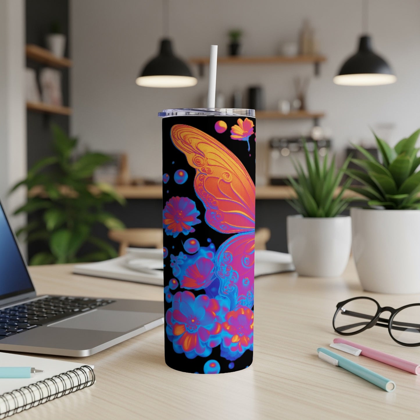 Tumbler with vibrant butterfly and floral design on black background.