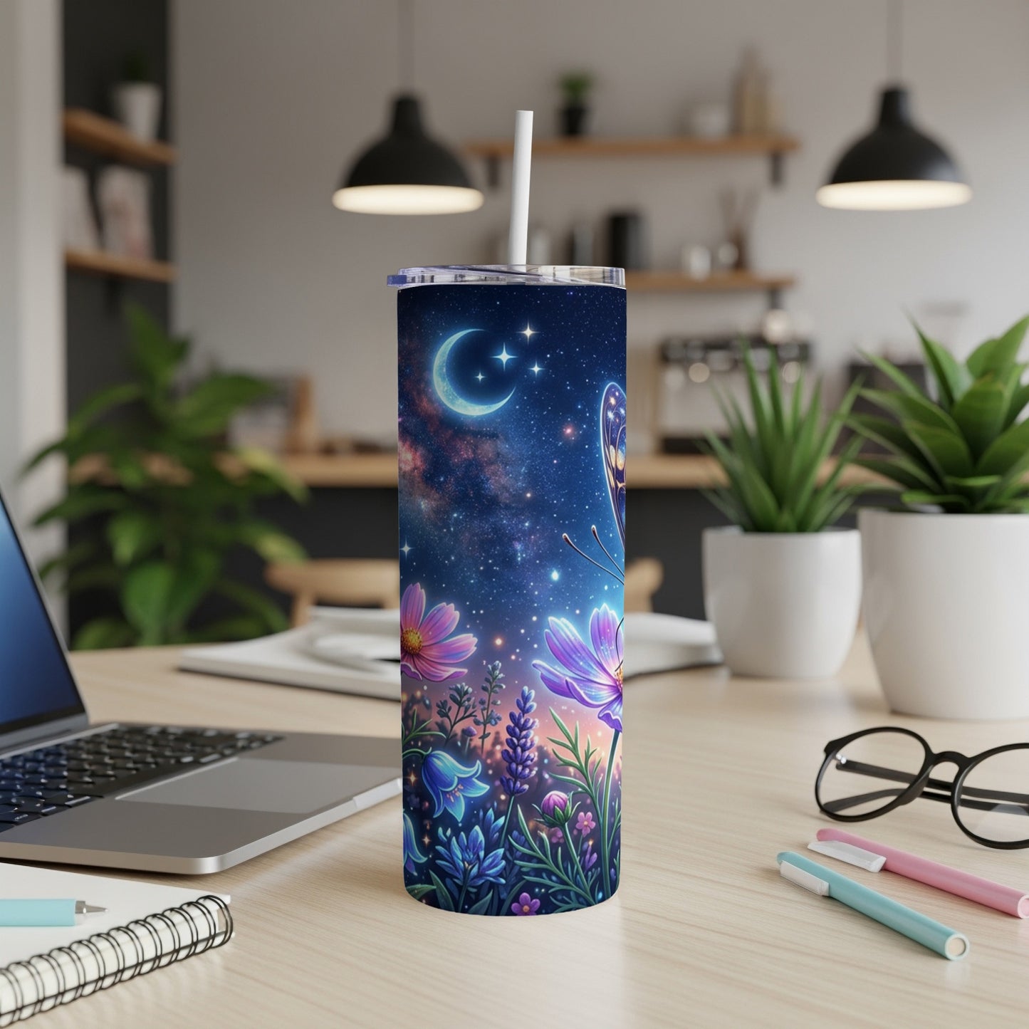 Celestial butterfly and floral design on a white tumbler with straw.