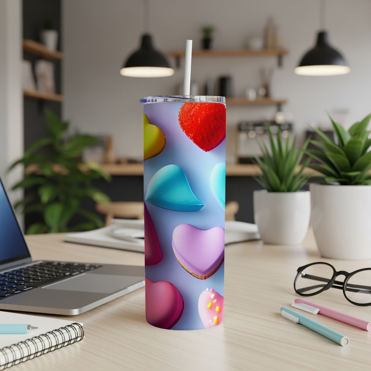 Purple tumbler with colorful heart shapes and a straw.