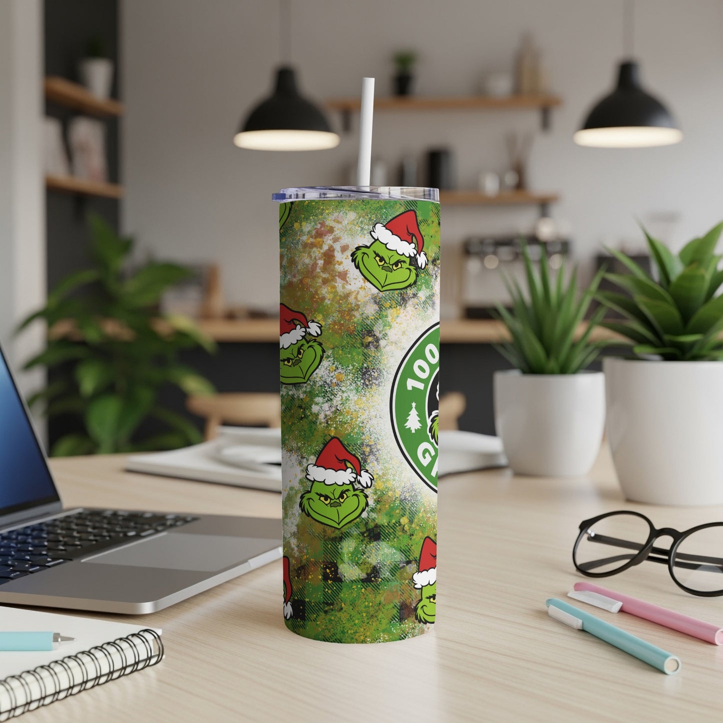 Grinch Christmas tumbler with green, red, and white pattern and straw.