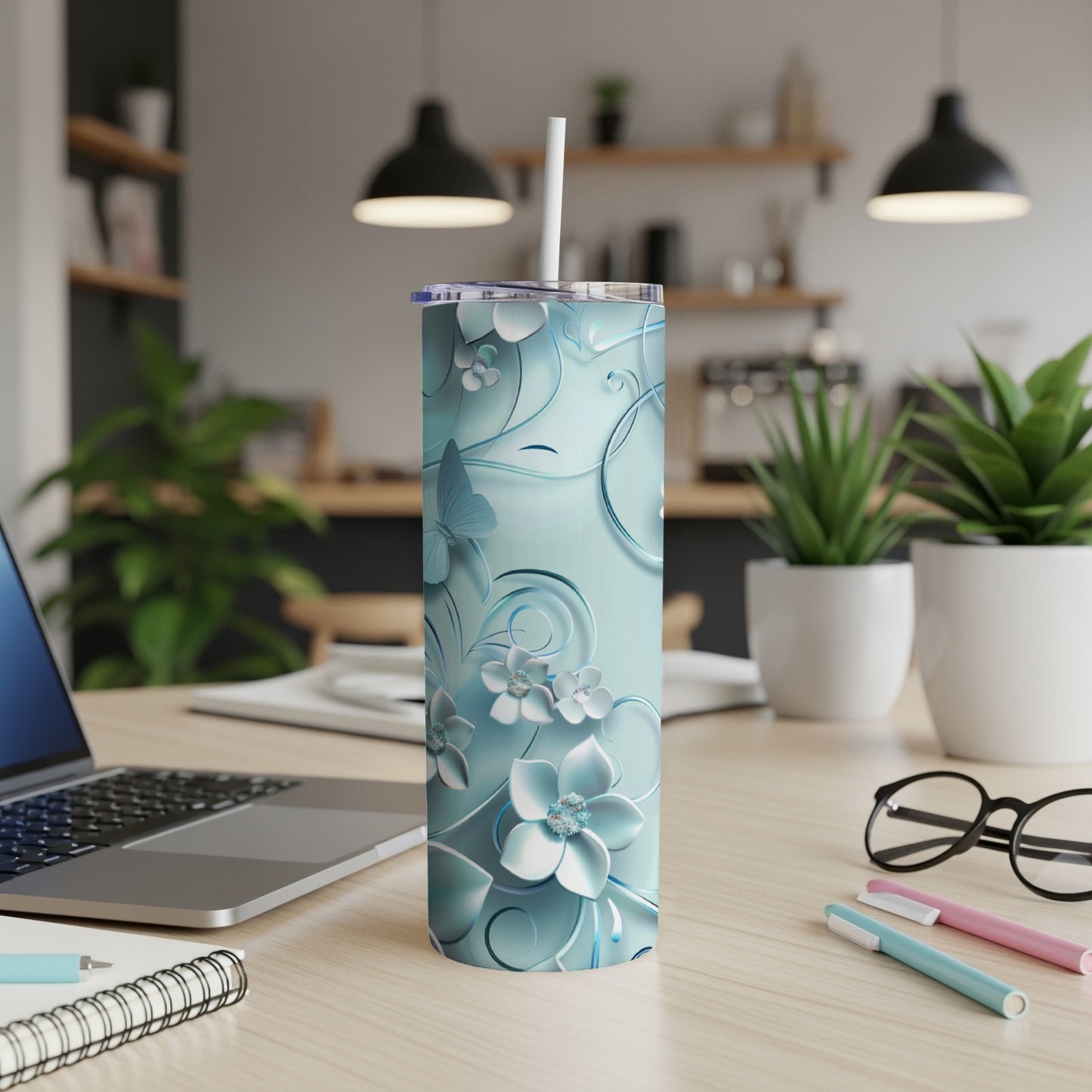 Pale blue tumbler with floral and butterfly pattern.