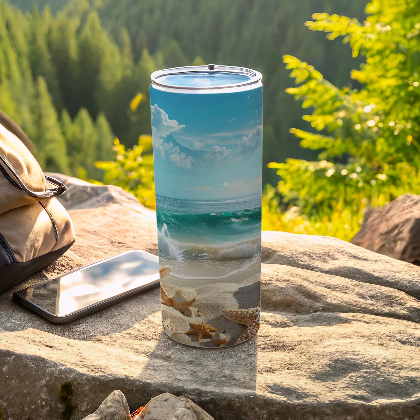 Beach scene tumbler with seashells, waves, and mountains on a rock.