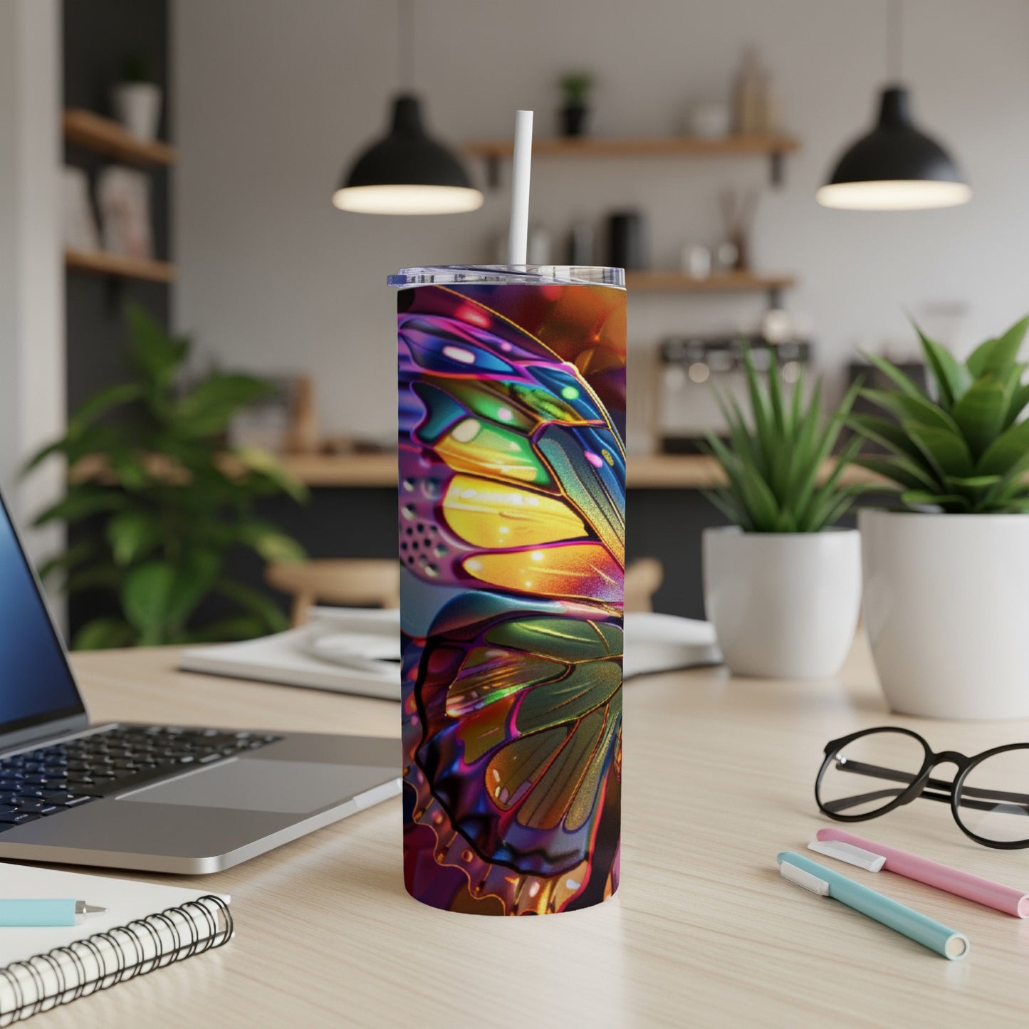 Colorful butterfly wing design on a white tumbler with a straw.