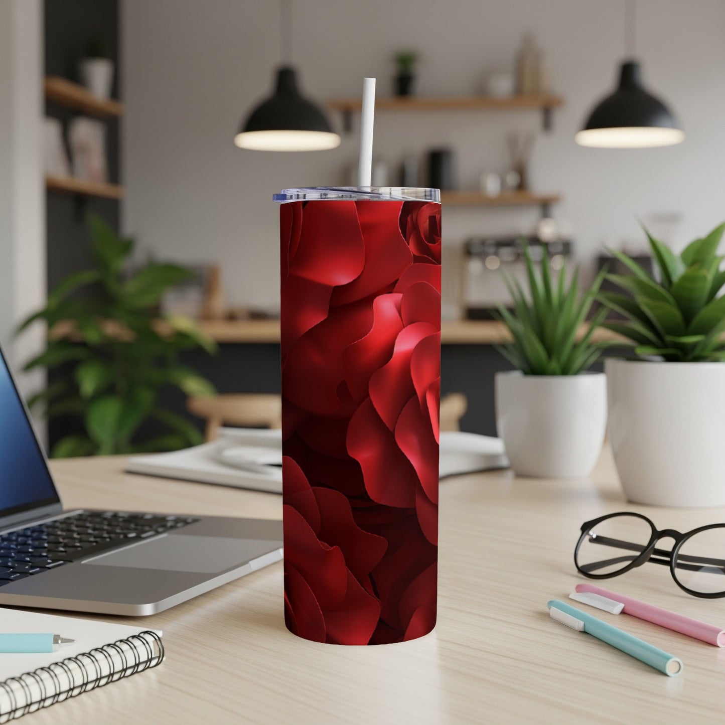 Red rose pattern on a stainless steel tumbler with a white straw.