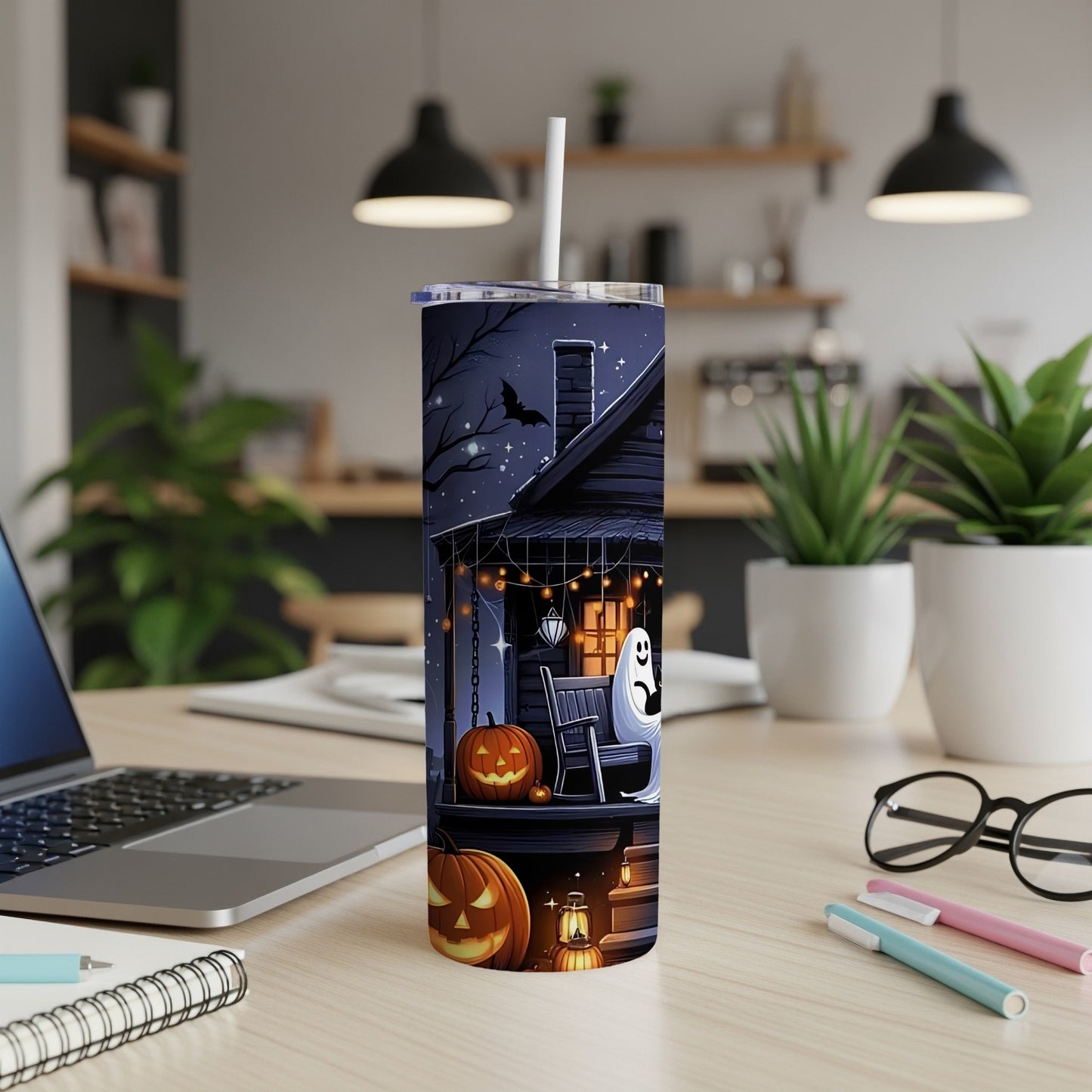 Halloween tumbler with pumpkins, a ghost, and a haunted house design.