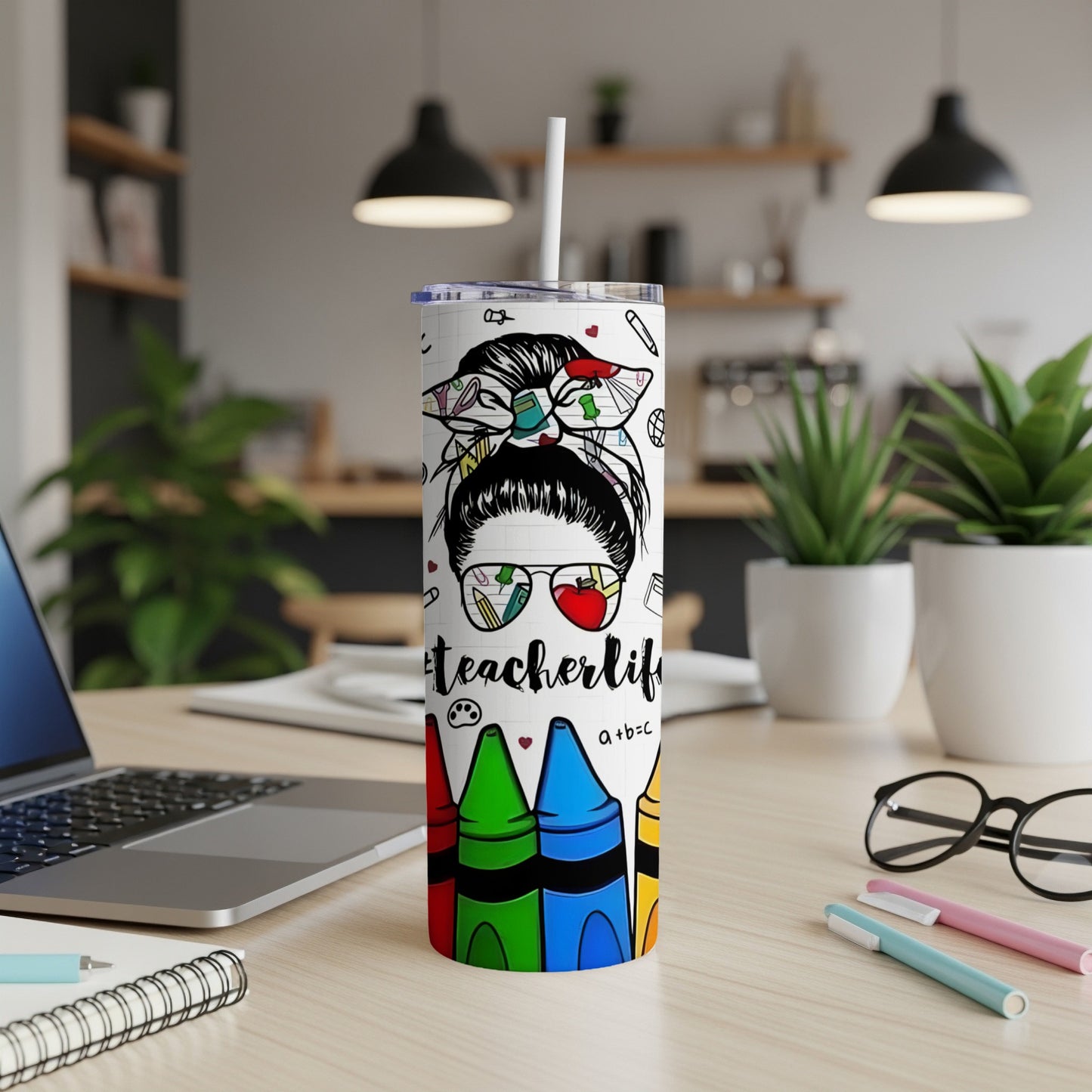 Teacher life tumbler with messy bun, glasses, and crayon graphic.