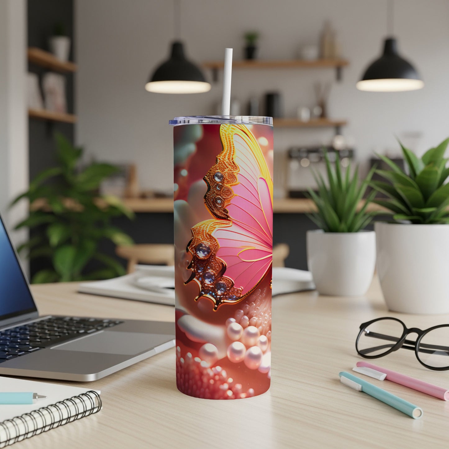Pink butterfly design on a white tumbler with a straw.