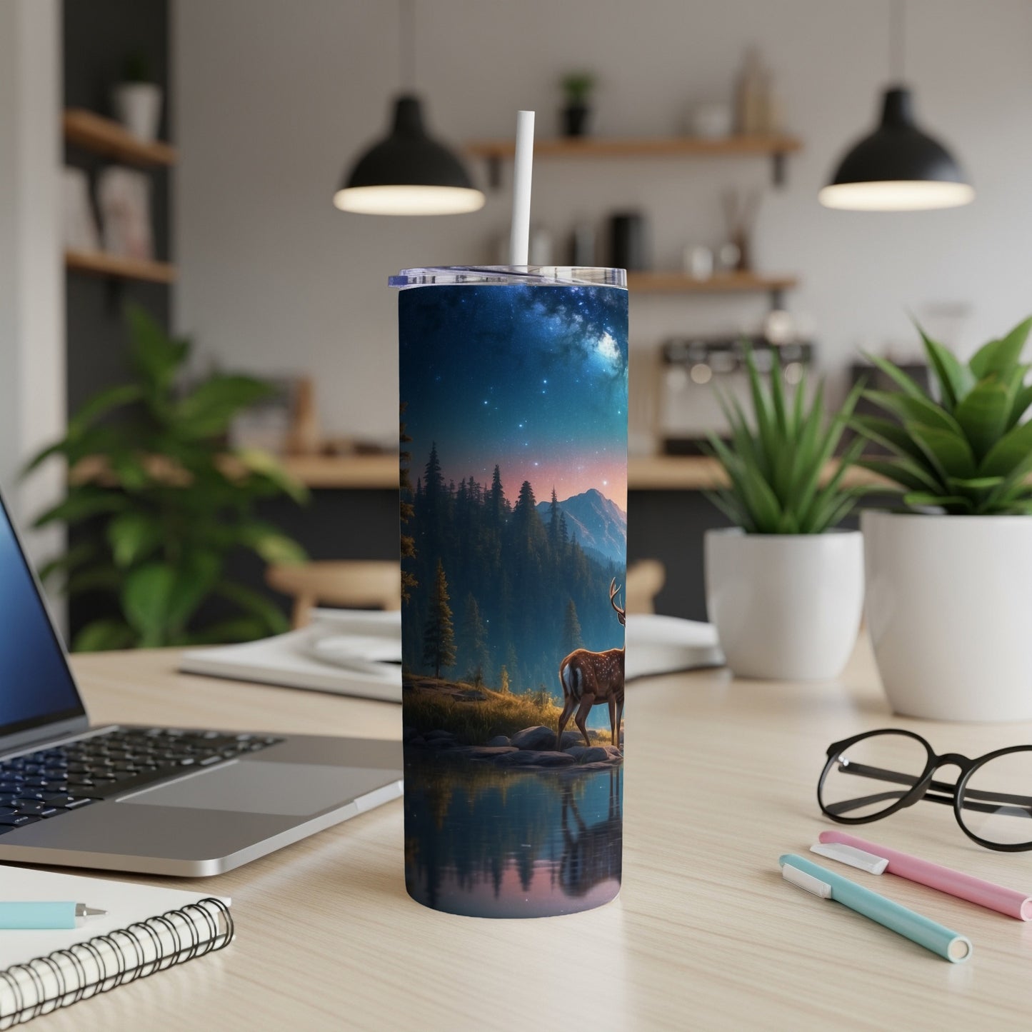 Deer in a starry forest reflected in water on a tumbler cup.