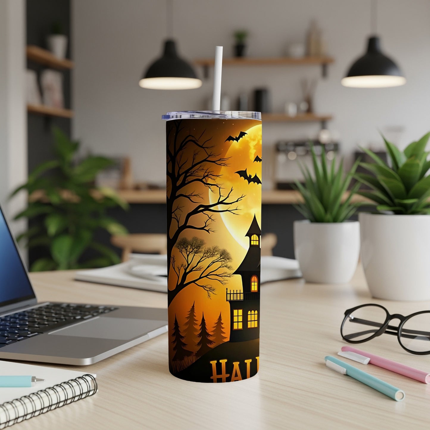 Halloween tumbler with haunted house, bats, moon, and trees, with "Halloween" text.