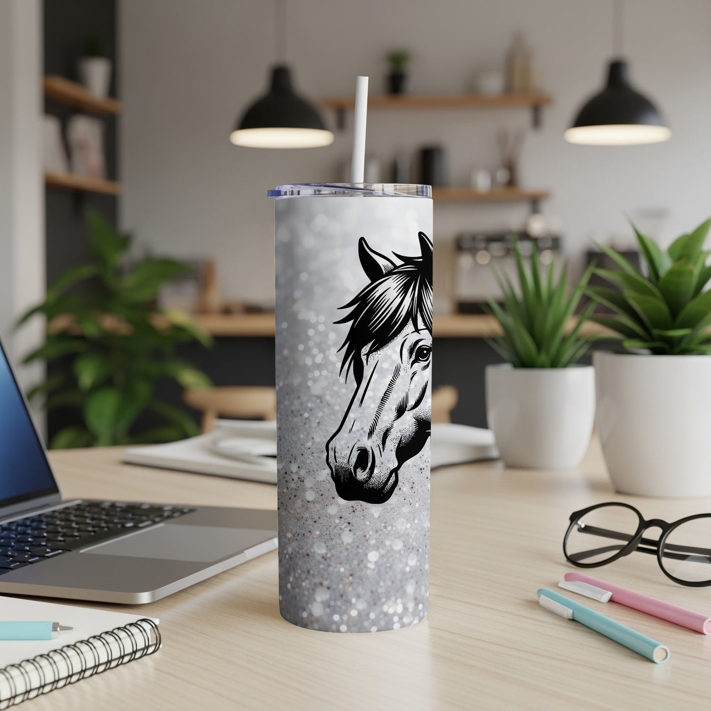 White glitter tumbler with a horse head illustration on a desk.