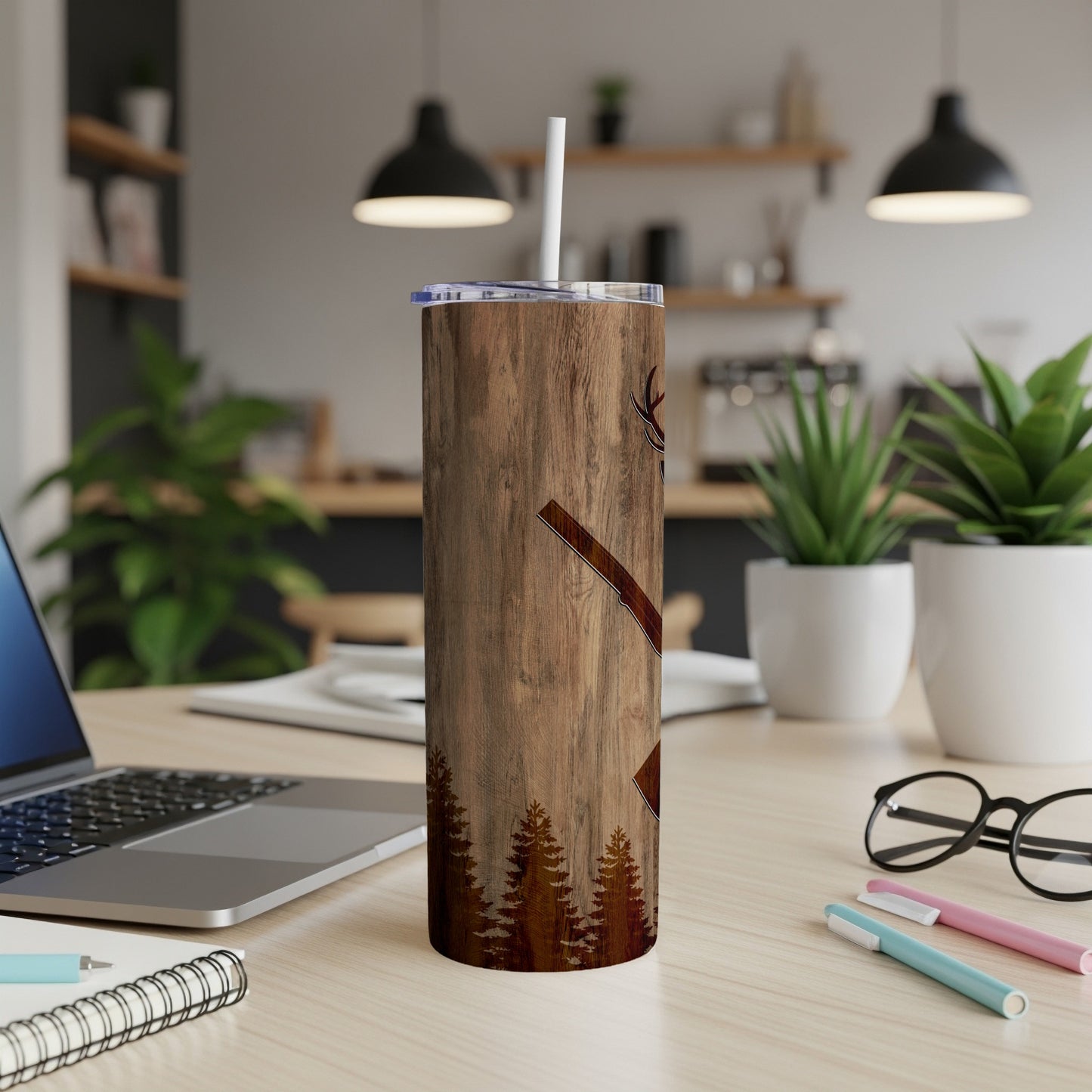 Wooden tumbler with axe graphic and forest silhouette.