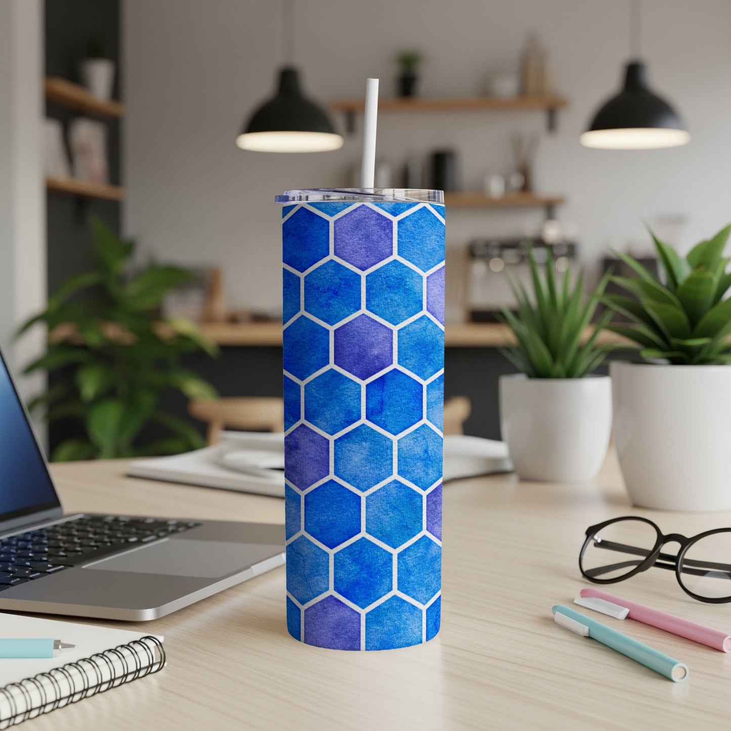 Blue and purple watercolor hexagon pattern tumbler with a white straw.