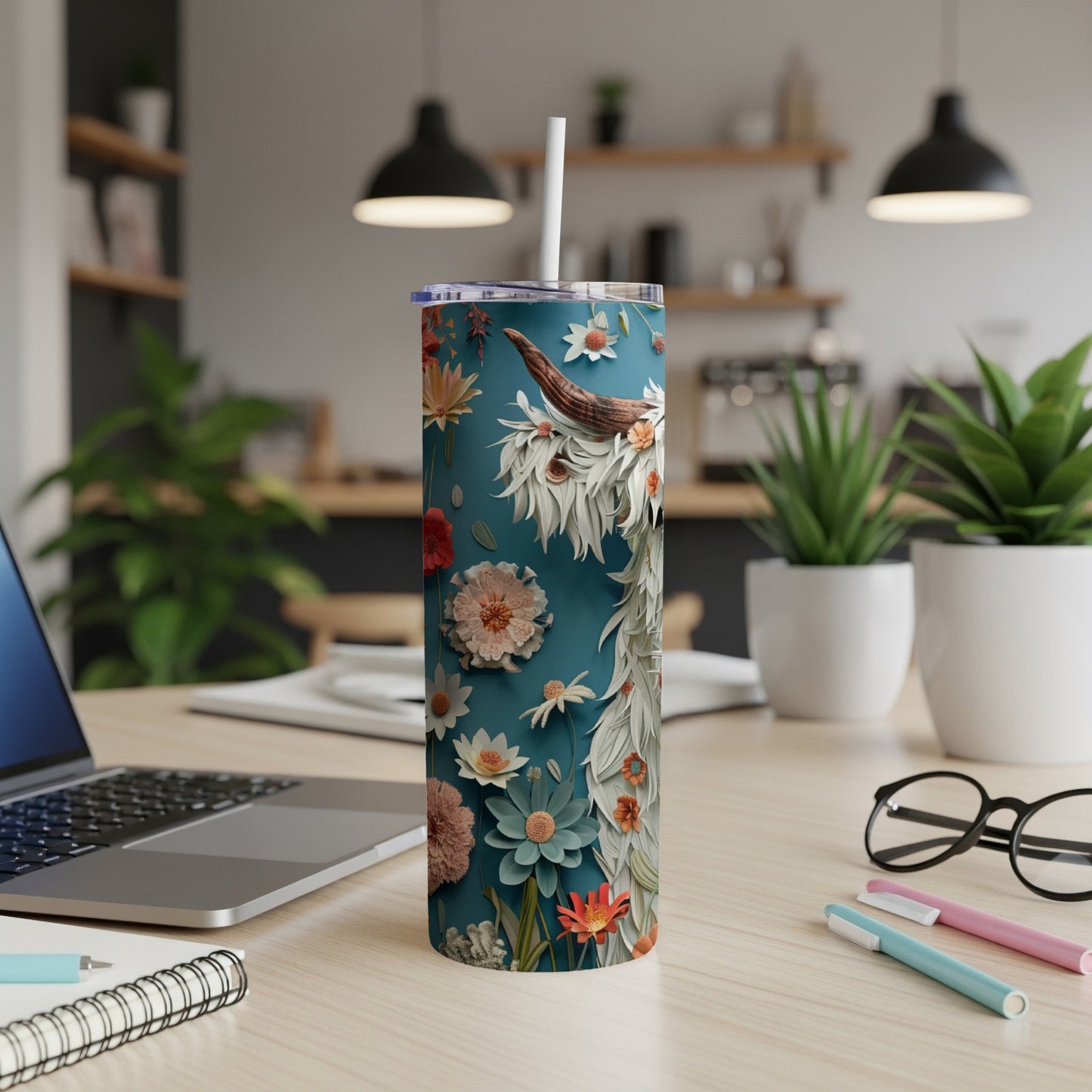 Teal tumbler with Highland cow and floral design, straw inserted.