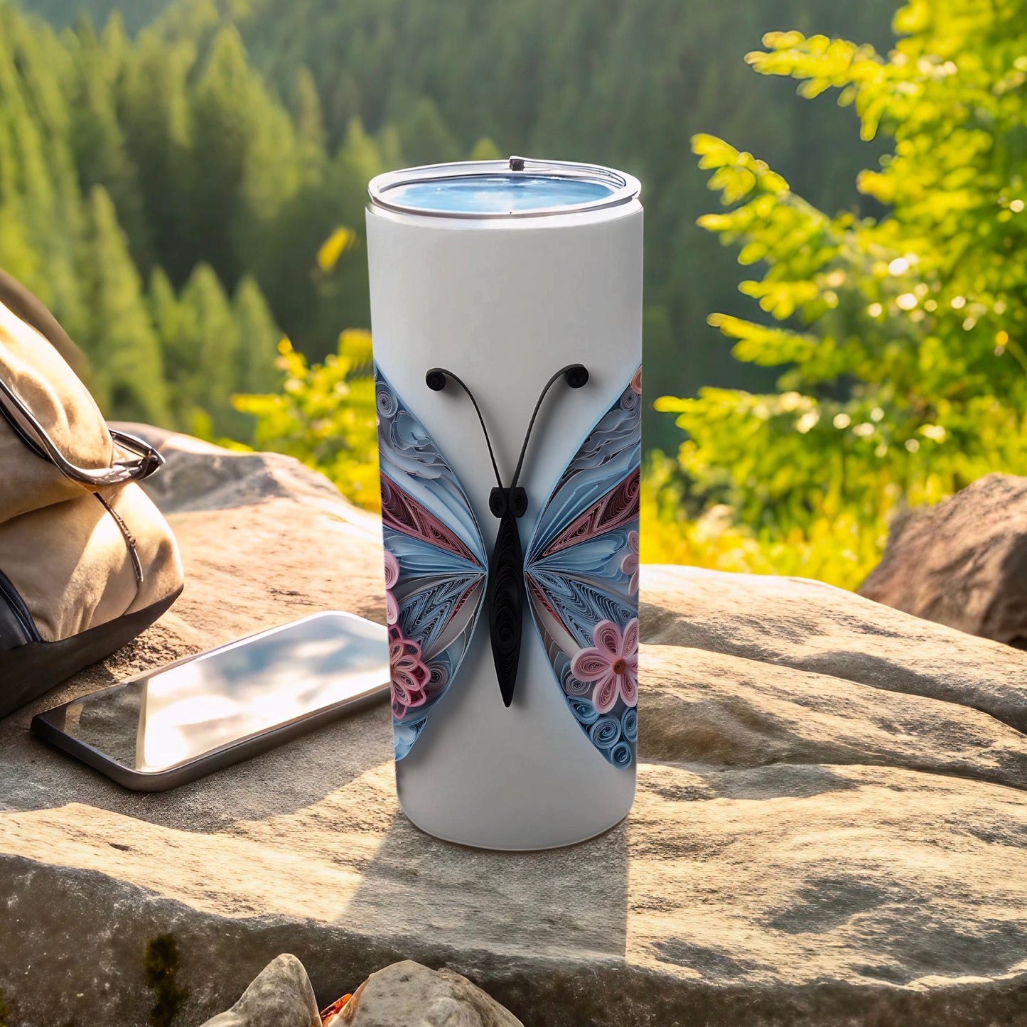 White tumbler with intricate blue butterfly design.