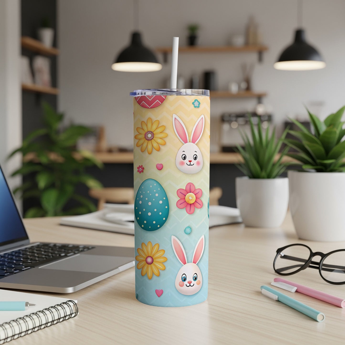 Easter bunny and egg tumbler with flowers on a desk.
