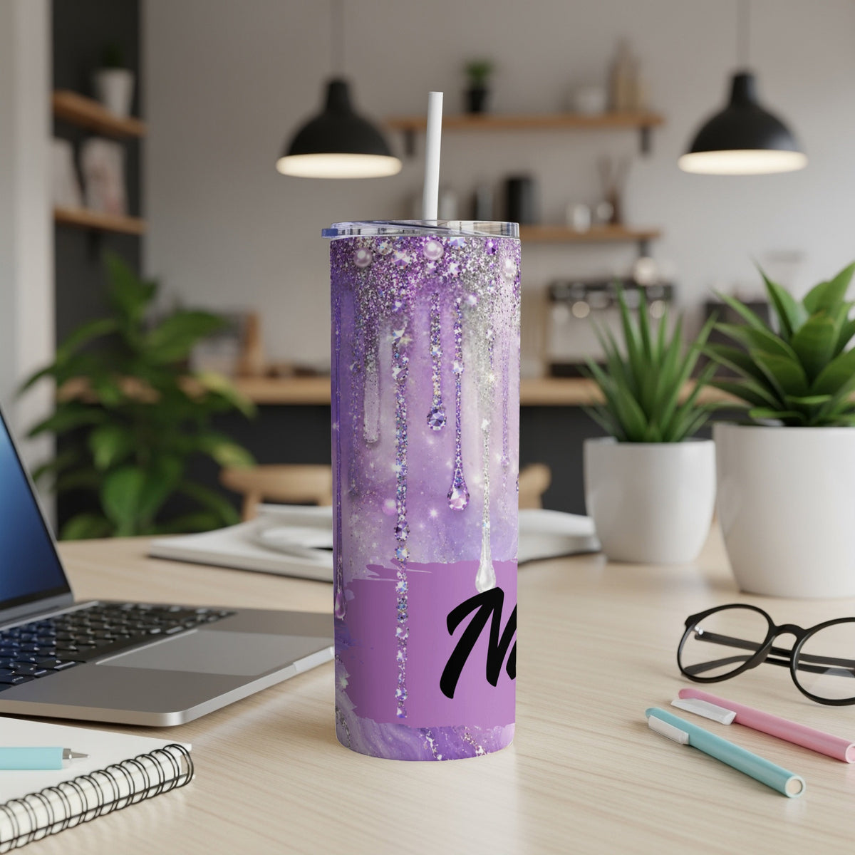 Purple glitter tumbler with white straw and black initial "M".