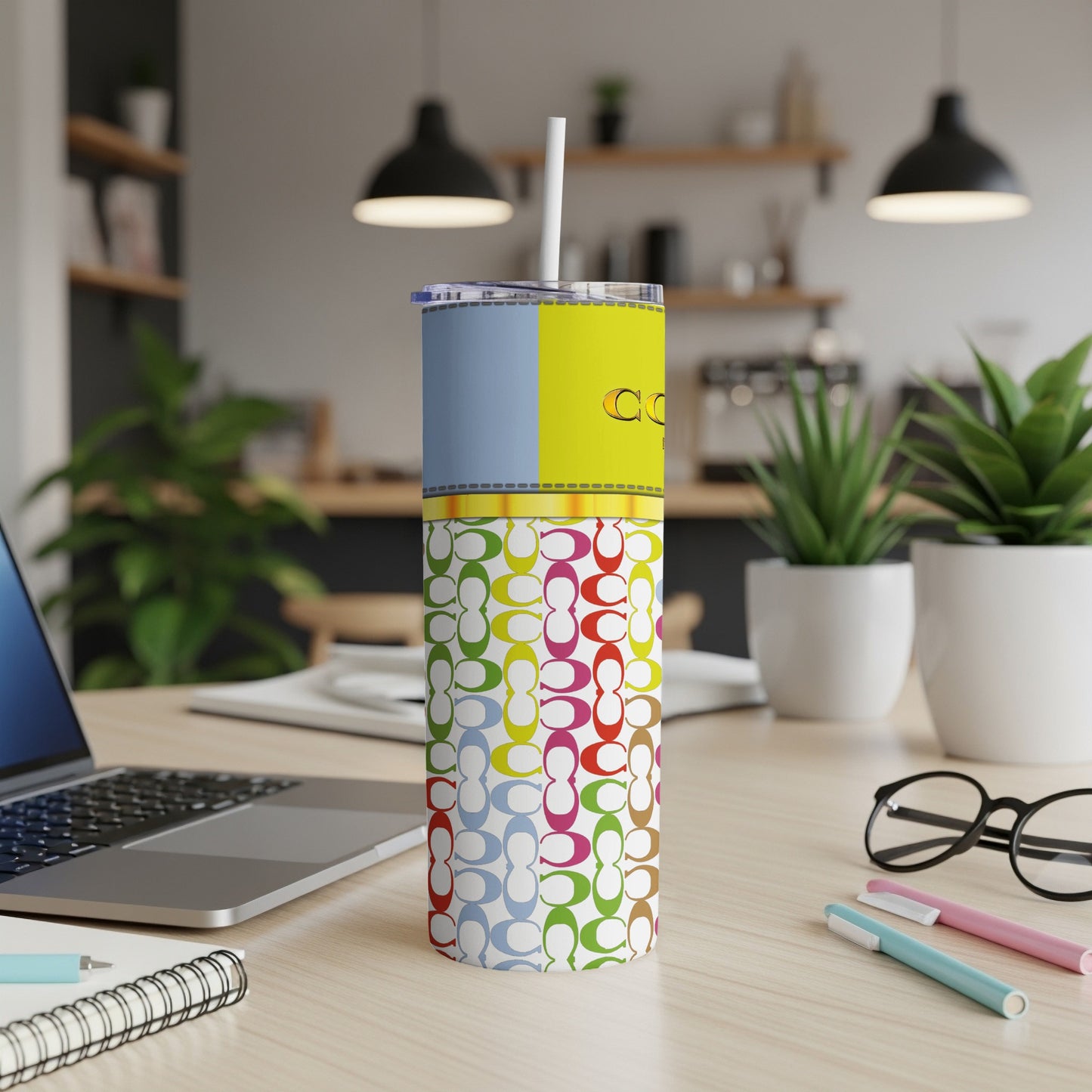 Tumbler with Coach logo pattern and yellow and blue color block top.