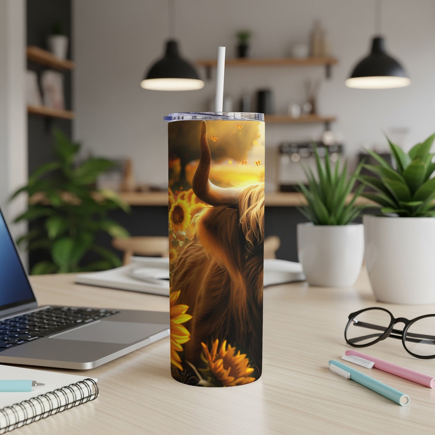 Highland cow illustration on a tumbler with sunflowers and a rustic background.