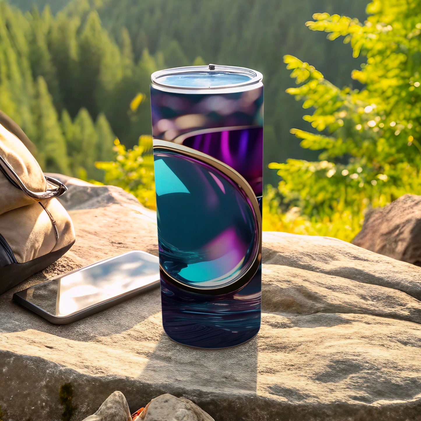 Abstract iridescent design on a tumbler next to a phone and backpack.