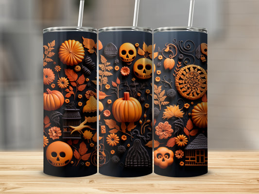 Tumbler with Halloween motifs of pumpkins, skulls, flowers, and leaves.