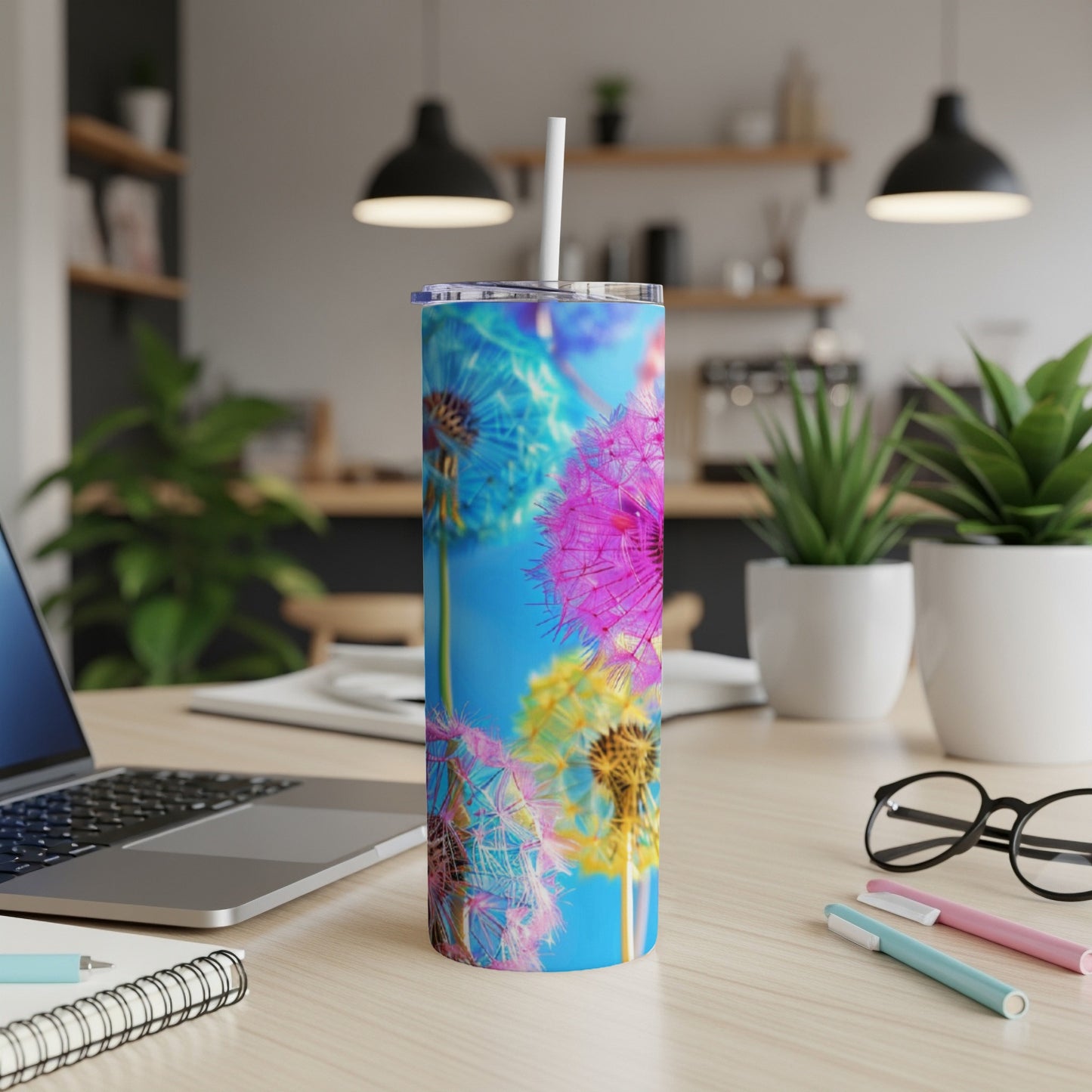 Tumbler with colorful dandelion puffballs against a bright blue background.
