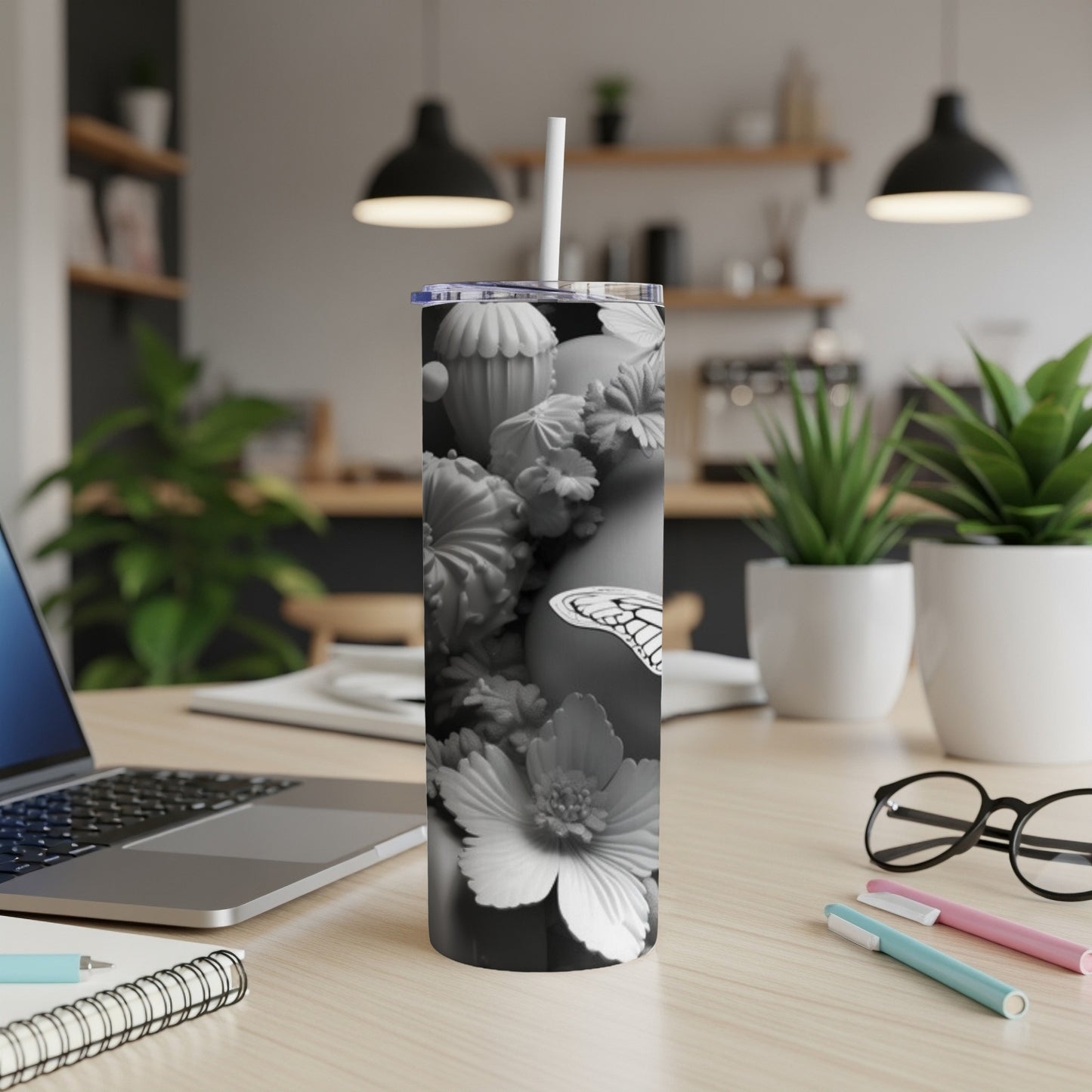 Gray and white floral patterned tumbler with a butterfly design.