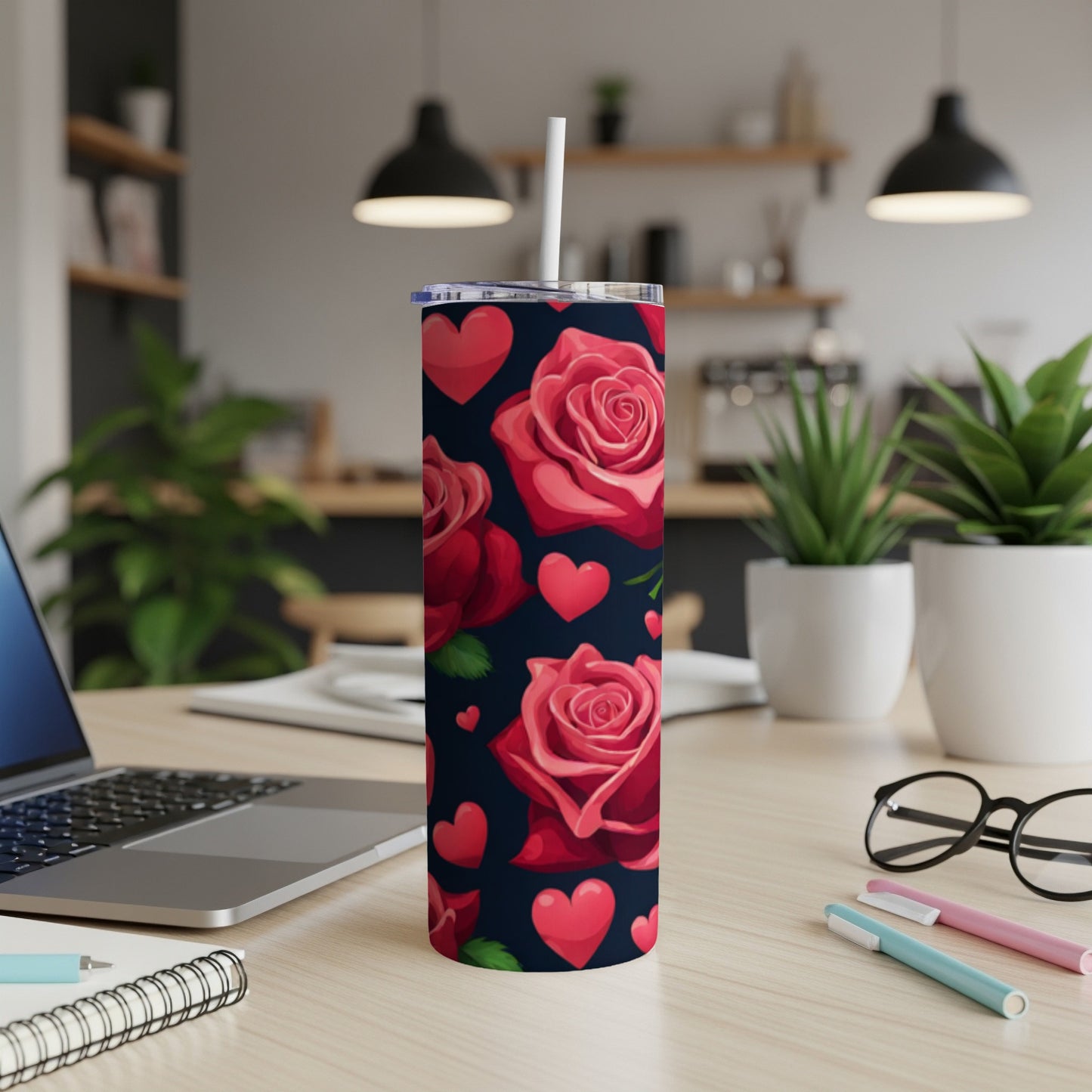 Tumbler with a repeating pattern of red roses and pink hearts on a dark background.