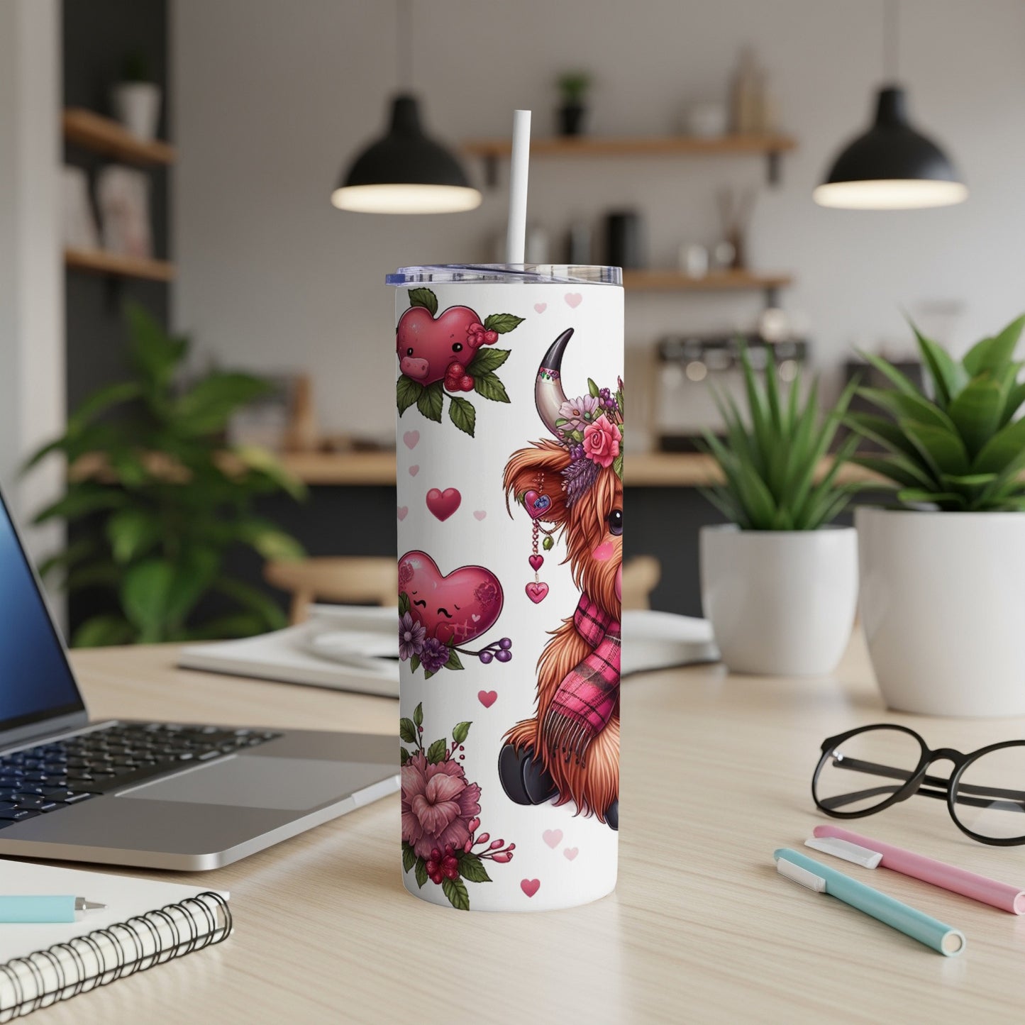 Highland cow with hearts and flowers on a tumbler.