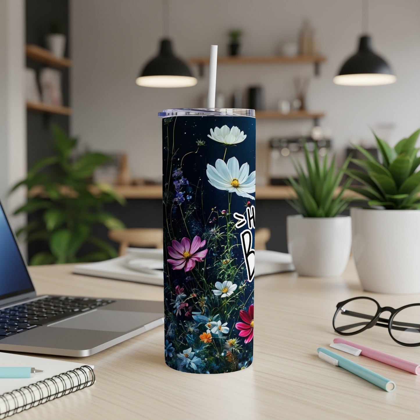 Floral tumbler with "Happy Birthday" text on a desk.