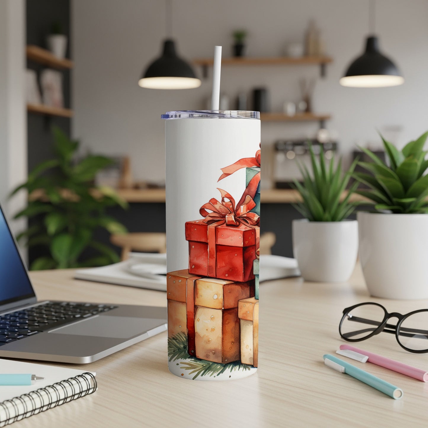 White tumbler with stacked Christmas gift boxes and pine sprigs.