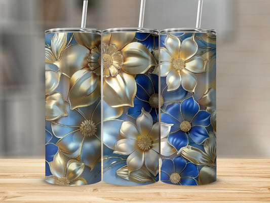 Gold and blue floral design on three tumblers with straws.