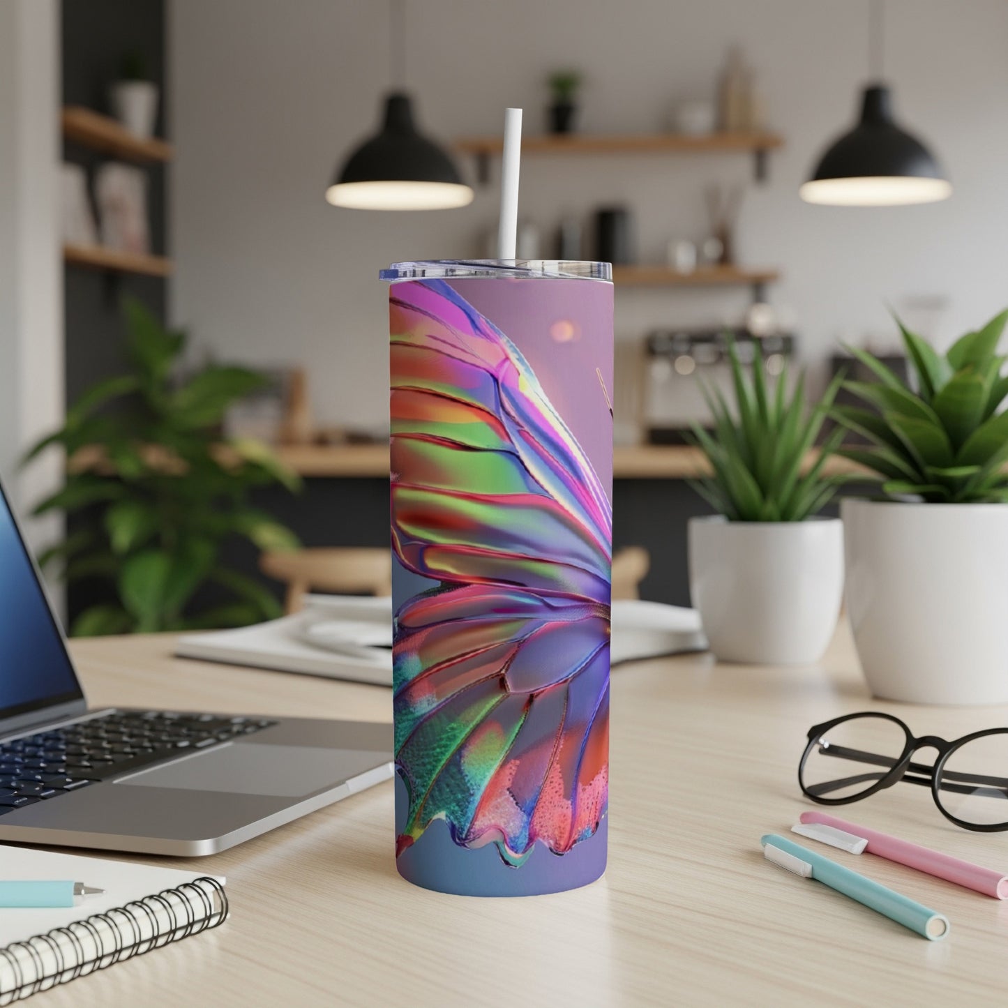Iridescent butterfly wing design on a stainless steel tumbler with straw.