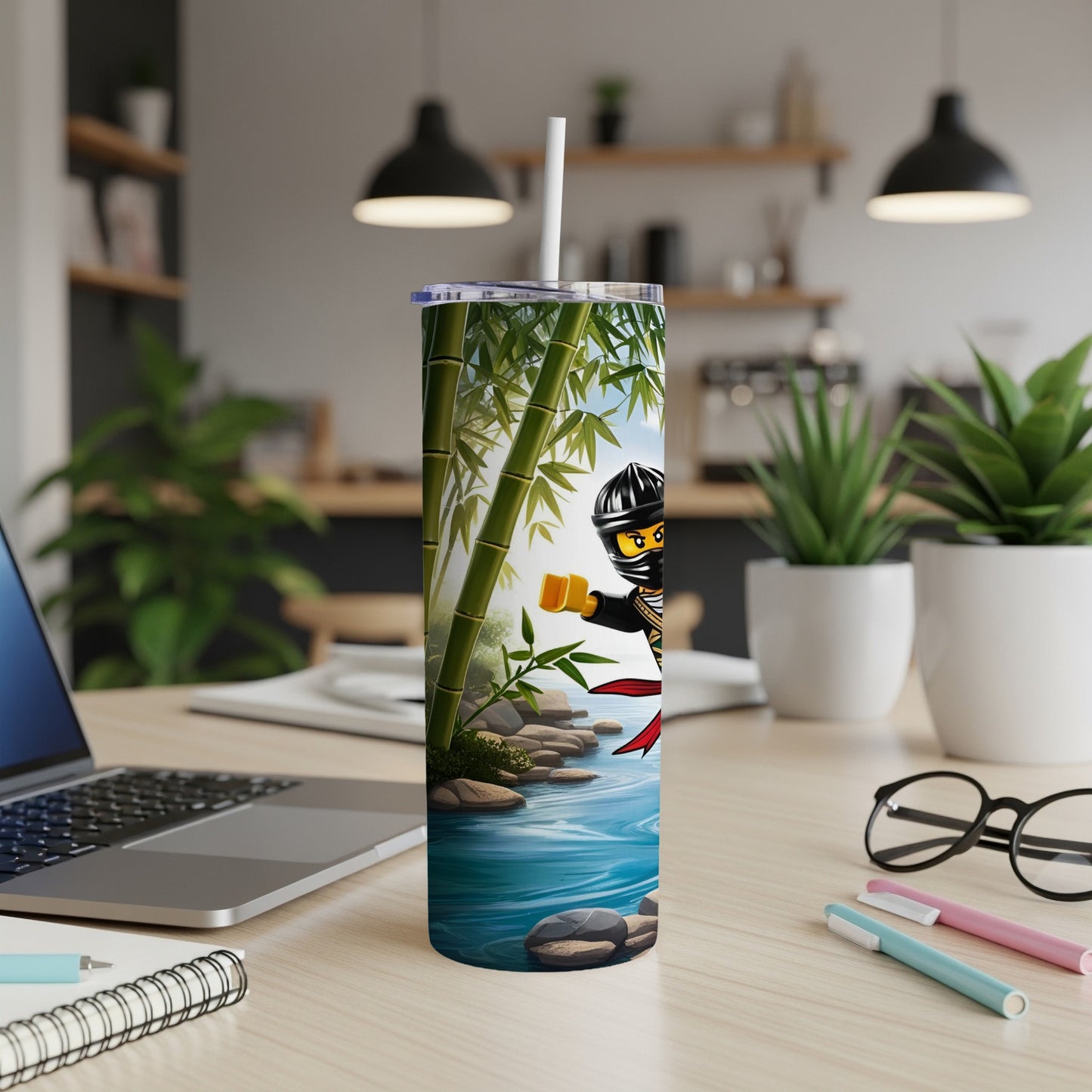 Ninja tumbler with bamboo and water design on desk.