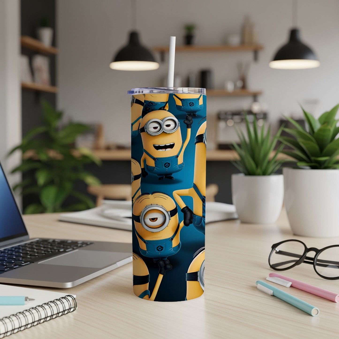Minions cartoon characters on a blue patterned tumbler with a straw.