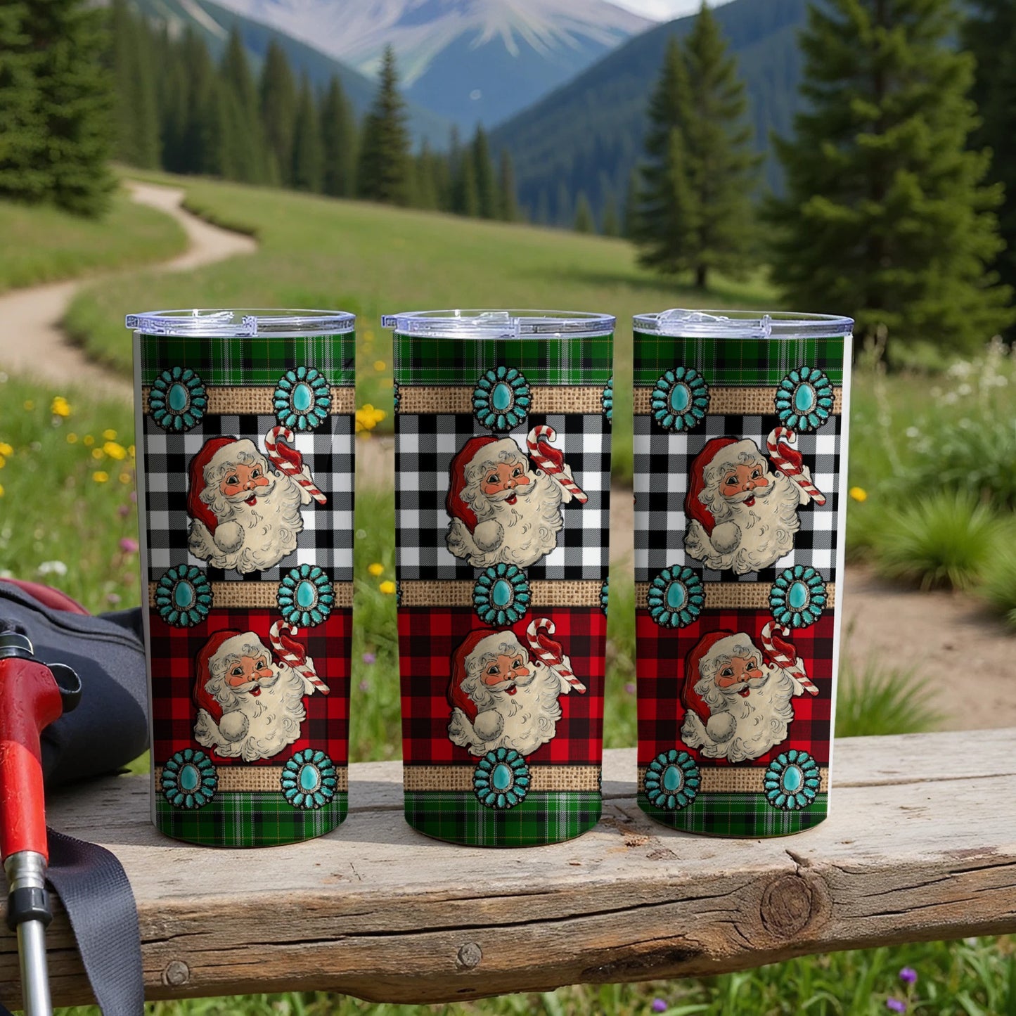 Three Santa-themed tumblers with buffalo plaid, turquoise, and candy cane designs.