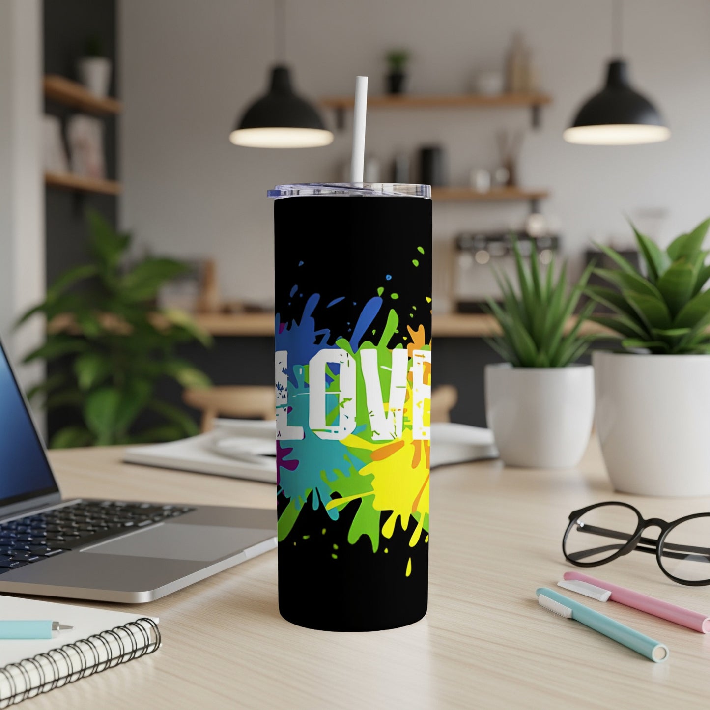Black tumbler with colorful paint splatters and "LOVE" text.
