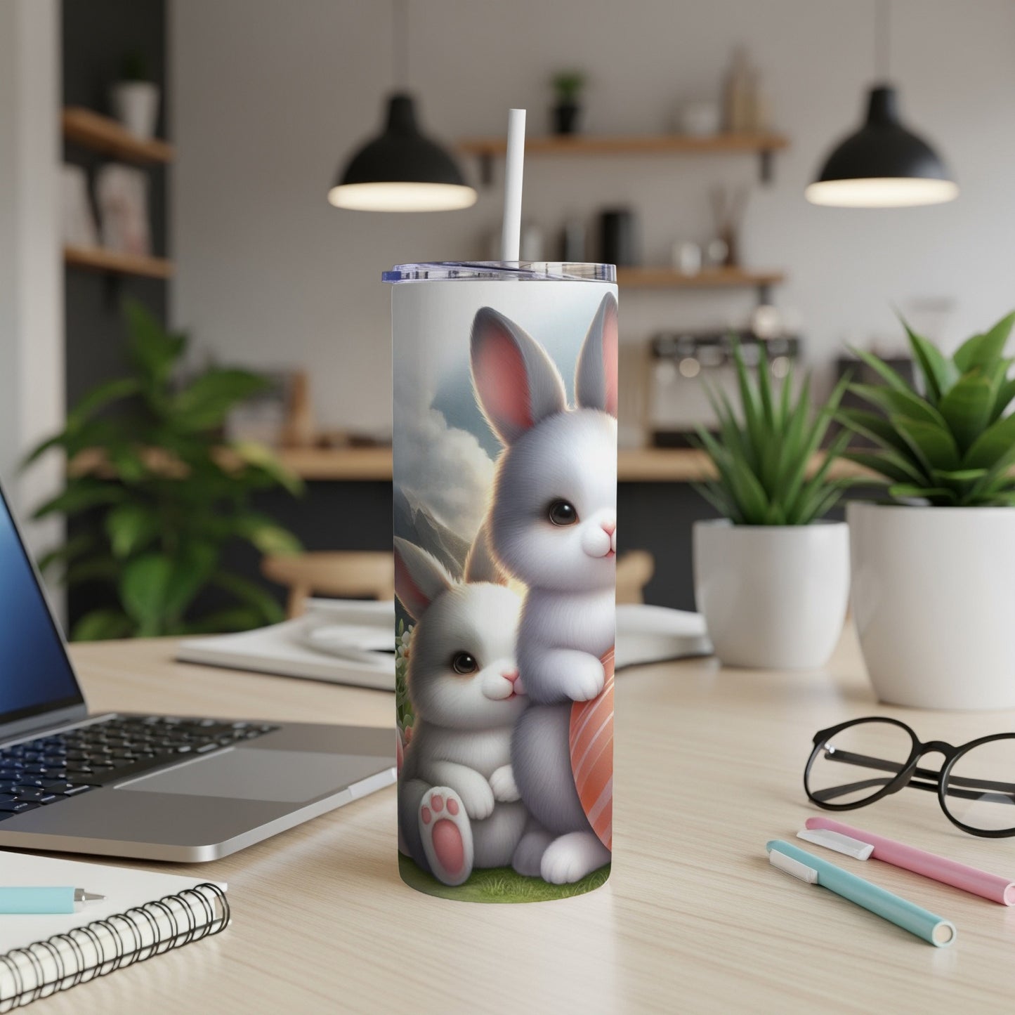Two cartoon bunnies, one with a painted egg, on a white tumbler.