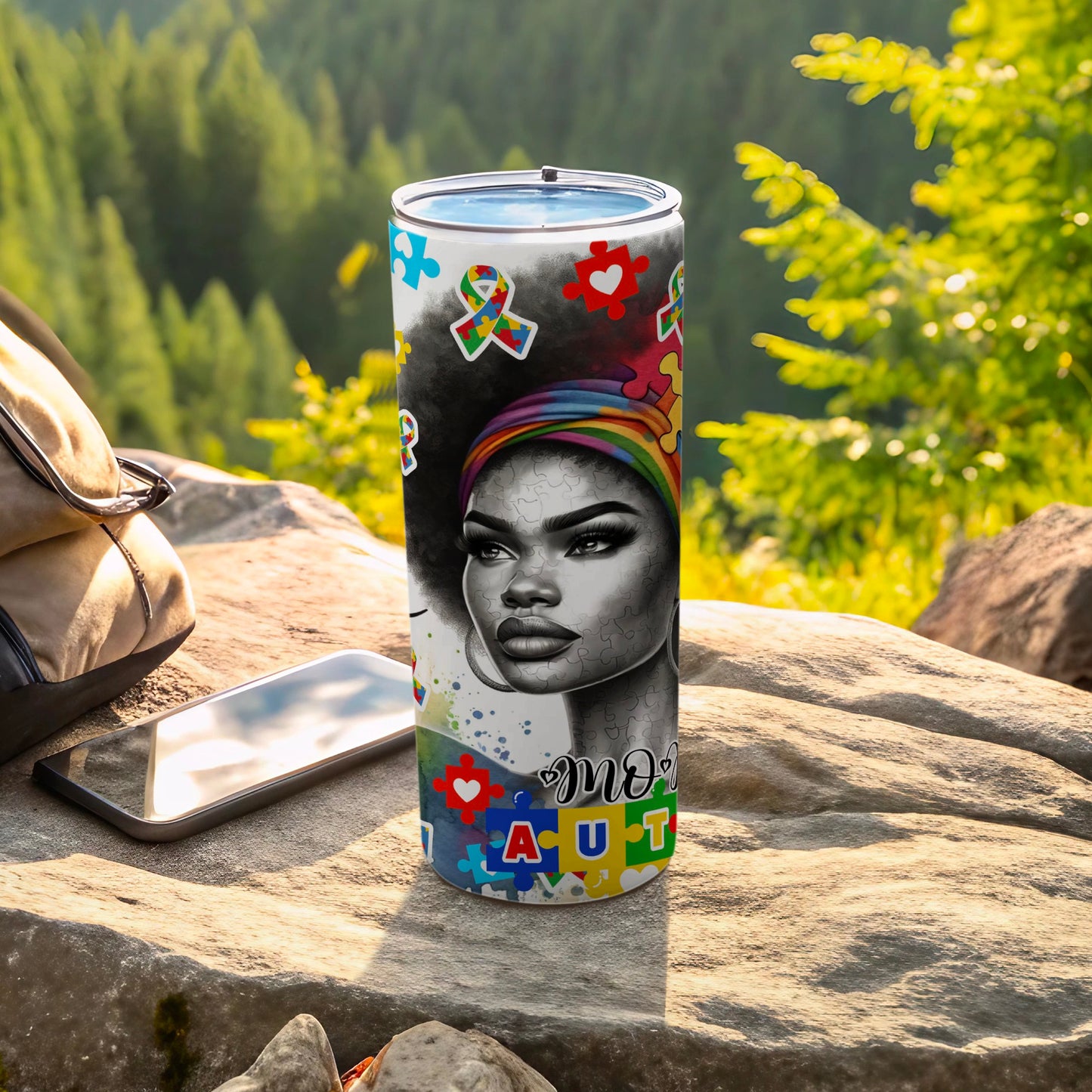 Tumbler with portrait of woman and autism awareness puzzle pieces.