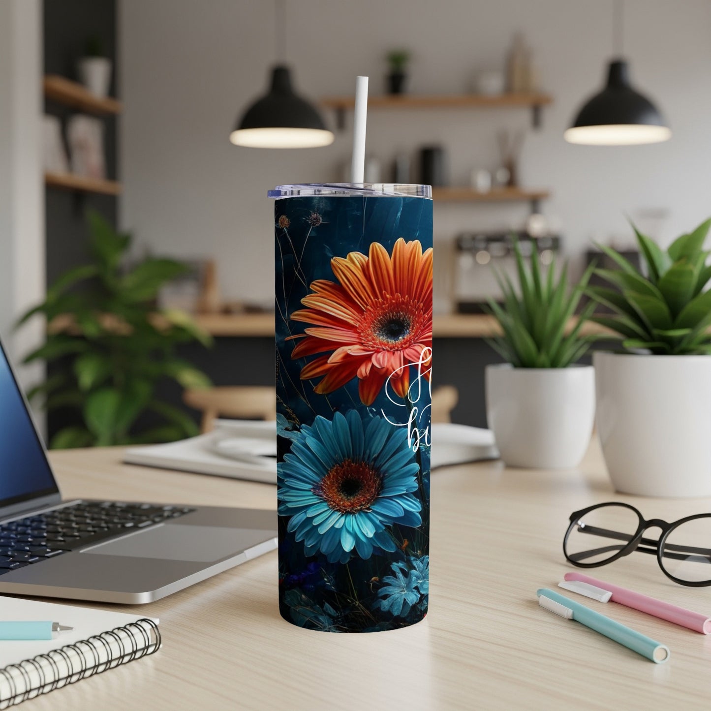 Tall tumbler with orange and blue gerbera daisies, white straw, and floral accents.