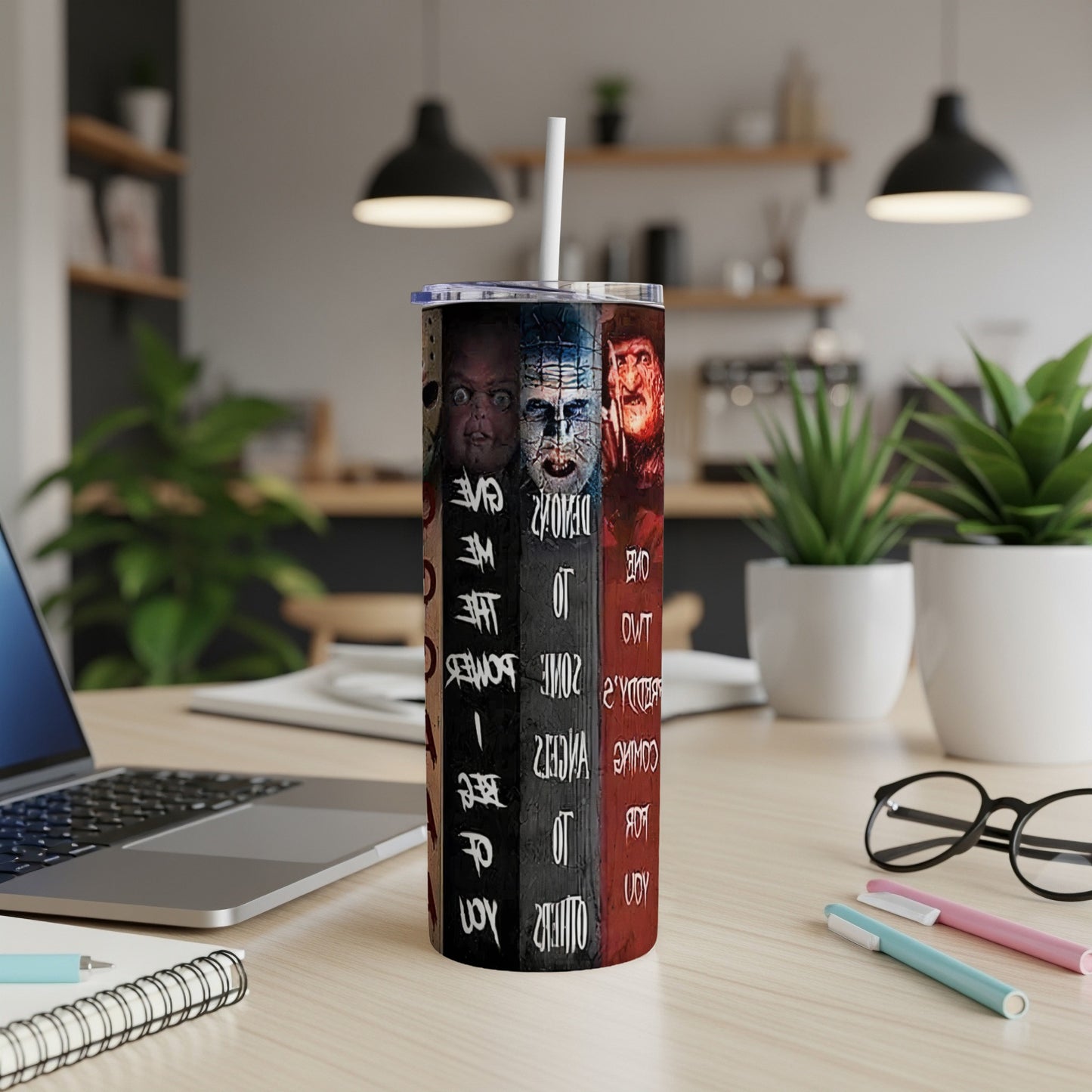 Tumbler with Hellraiser characters and film titles on a desk.