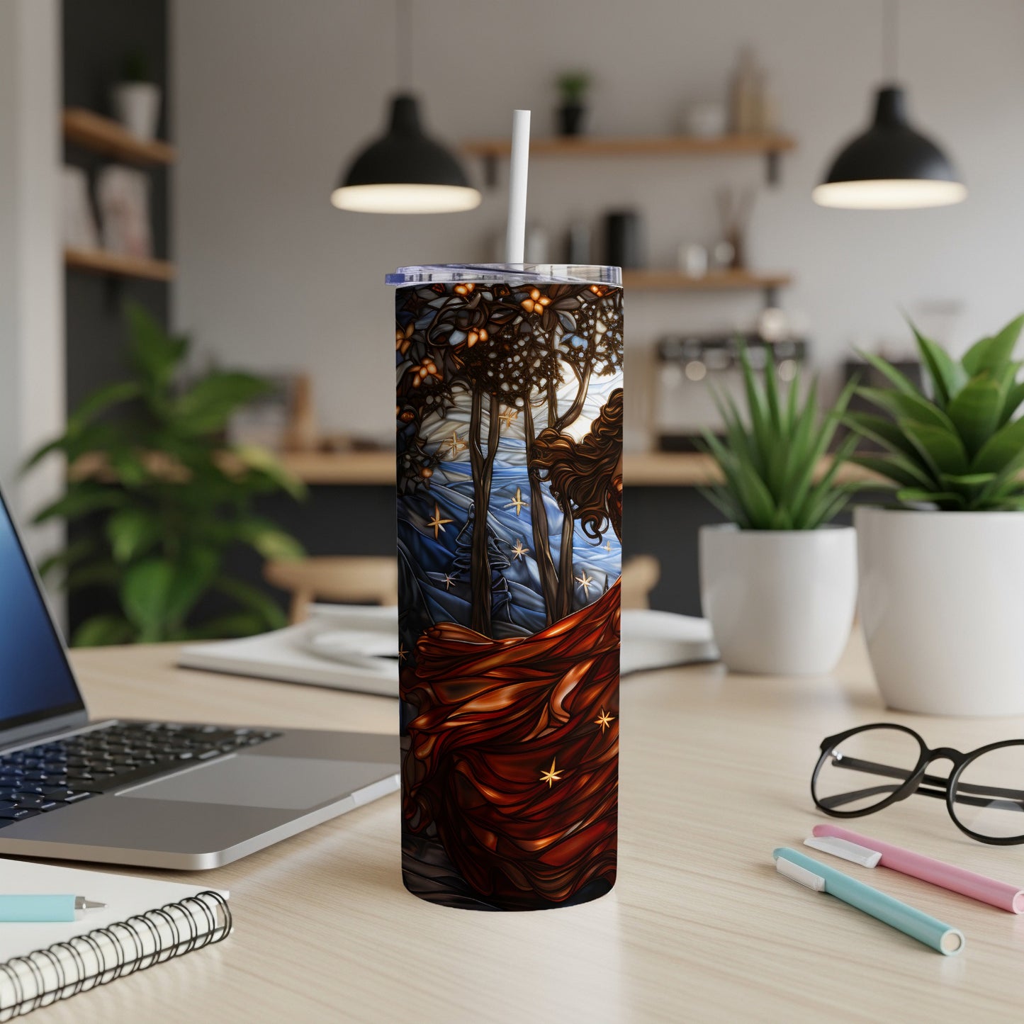 Tall tumbler with stained glass art of a woman with flowing hair and trees.