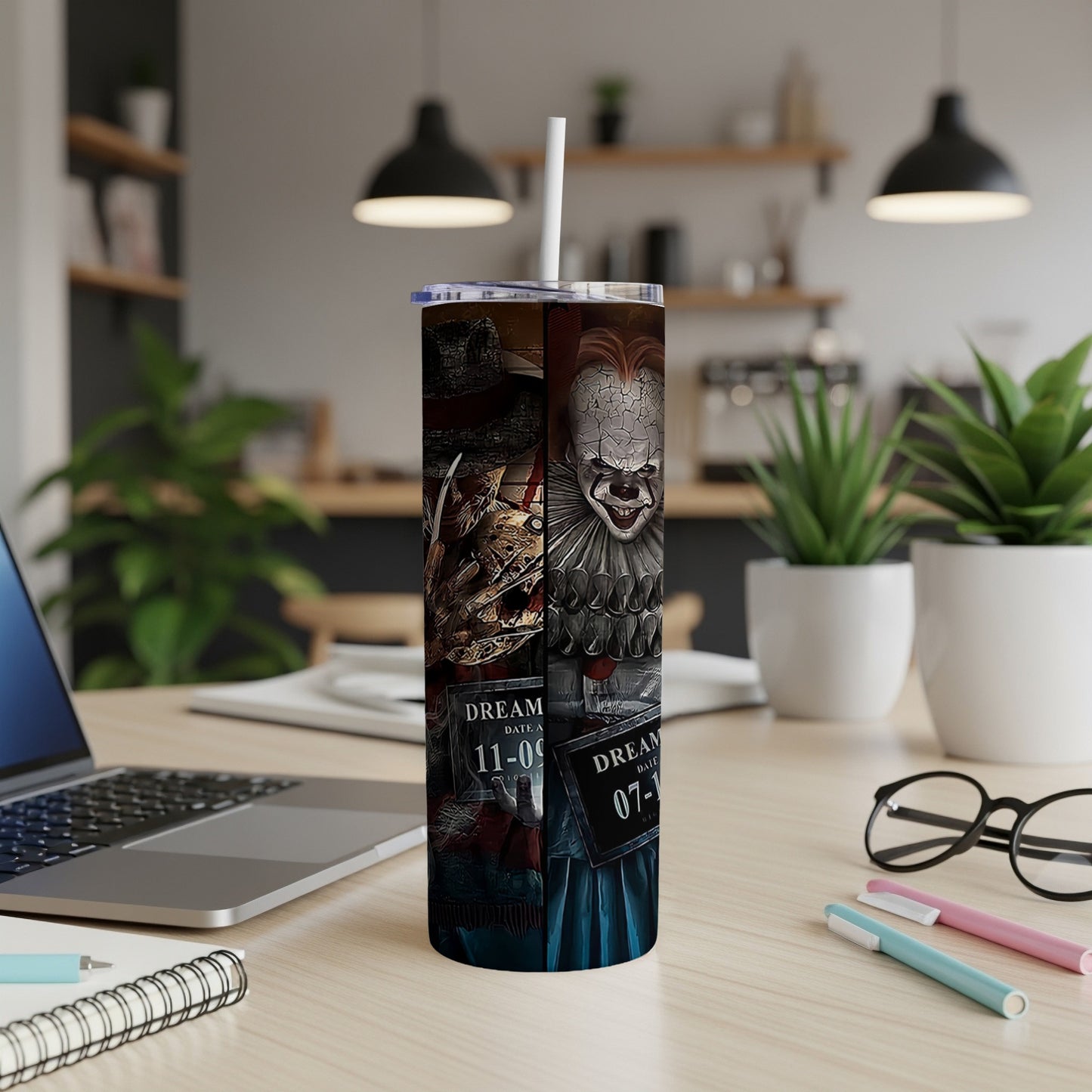Pennywise the Clown's face on a stainless steel tumbler with a straw.