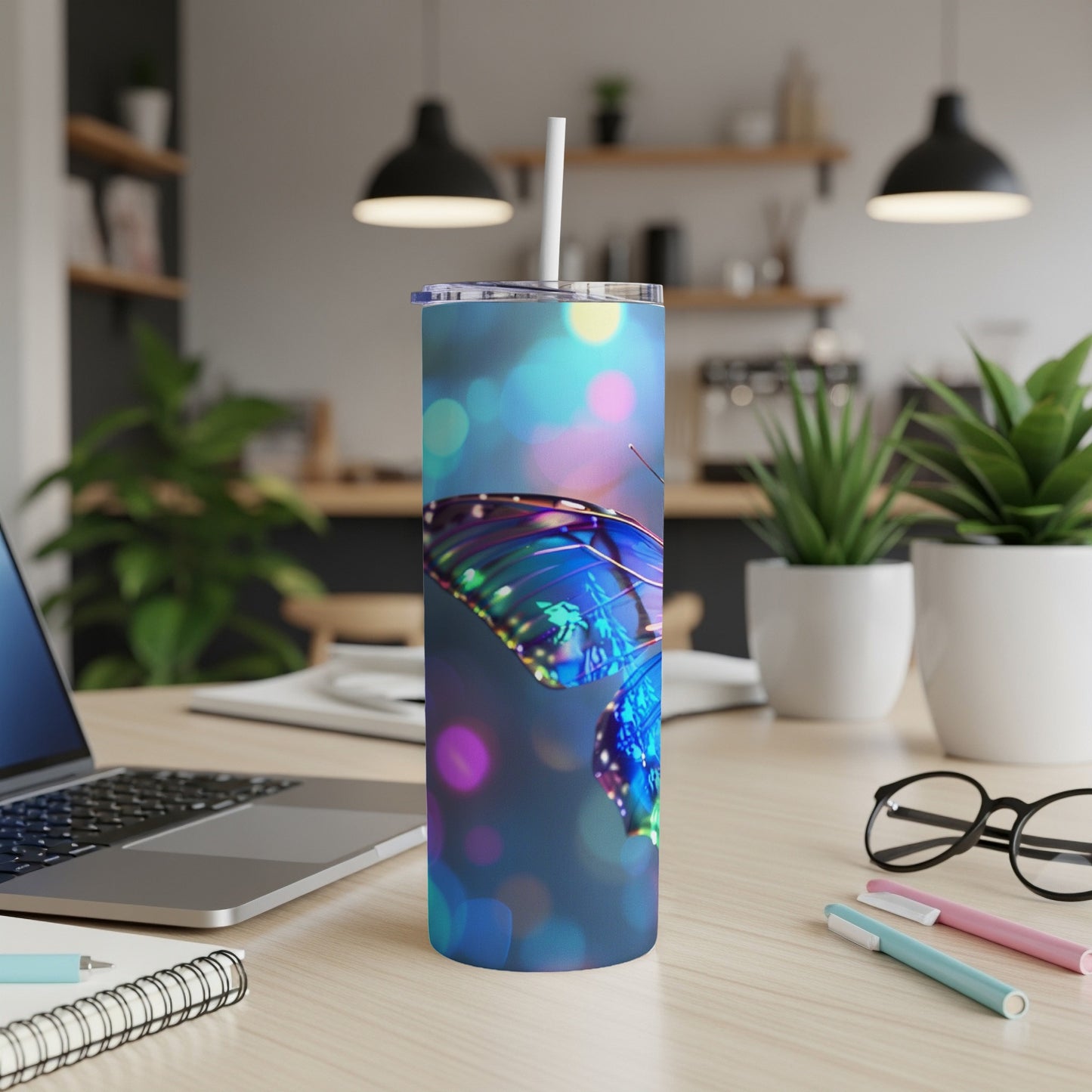 Blue butterfly design on a white tumbler with a straw.