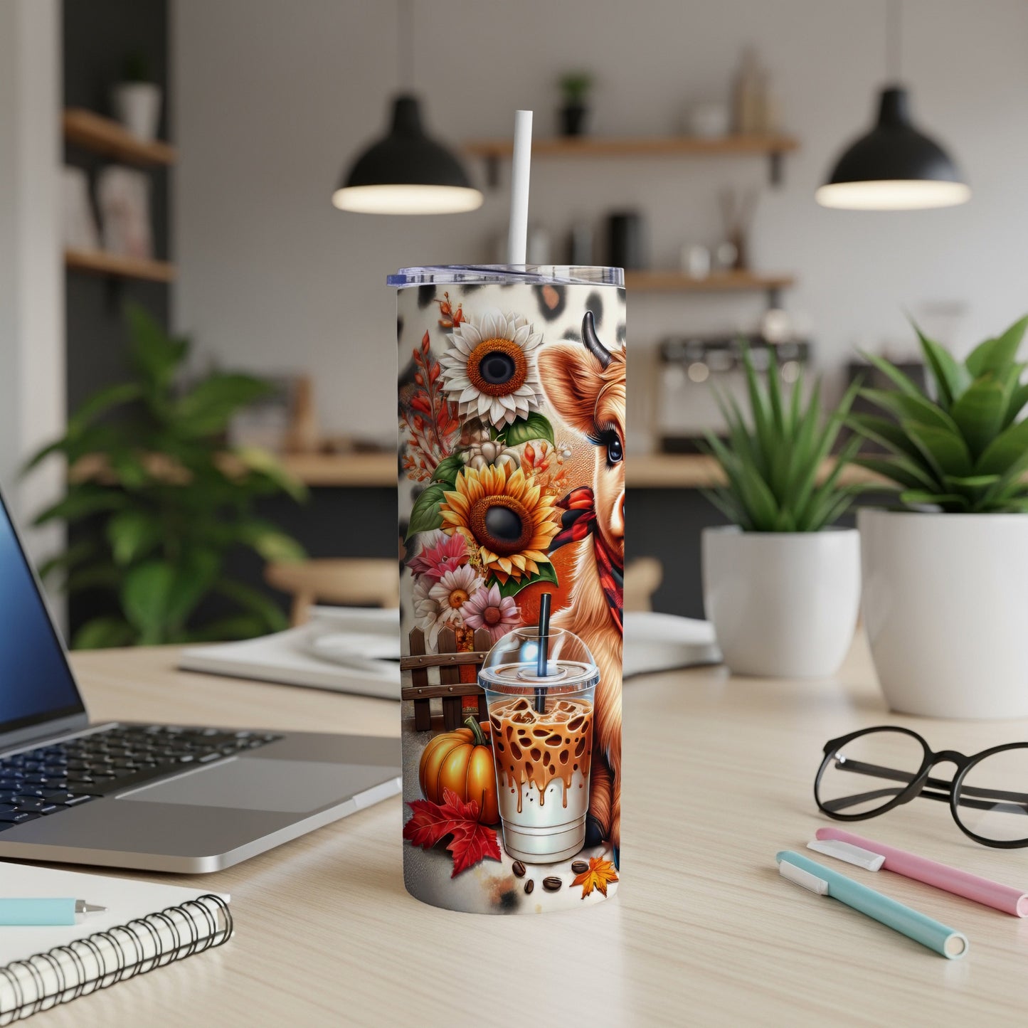 Cow and sunflowers on a tumbler with iced coffee and autumn leaves.