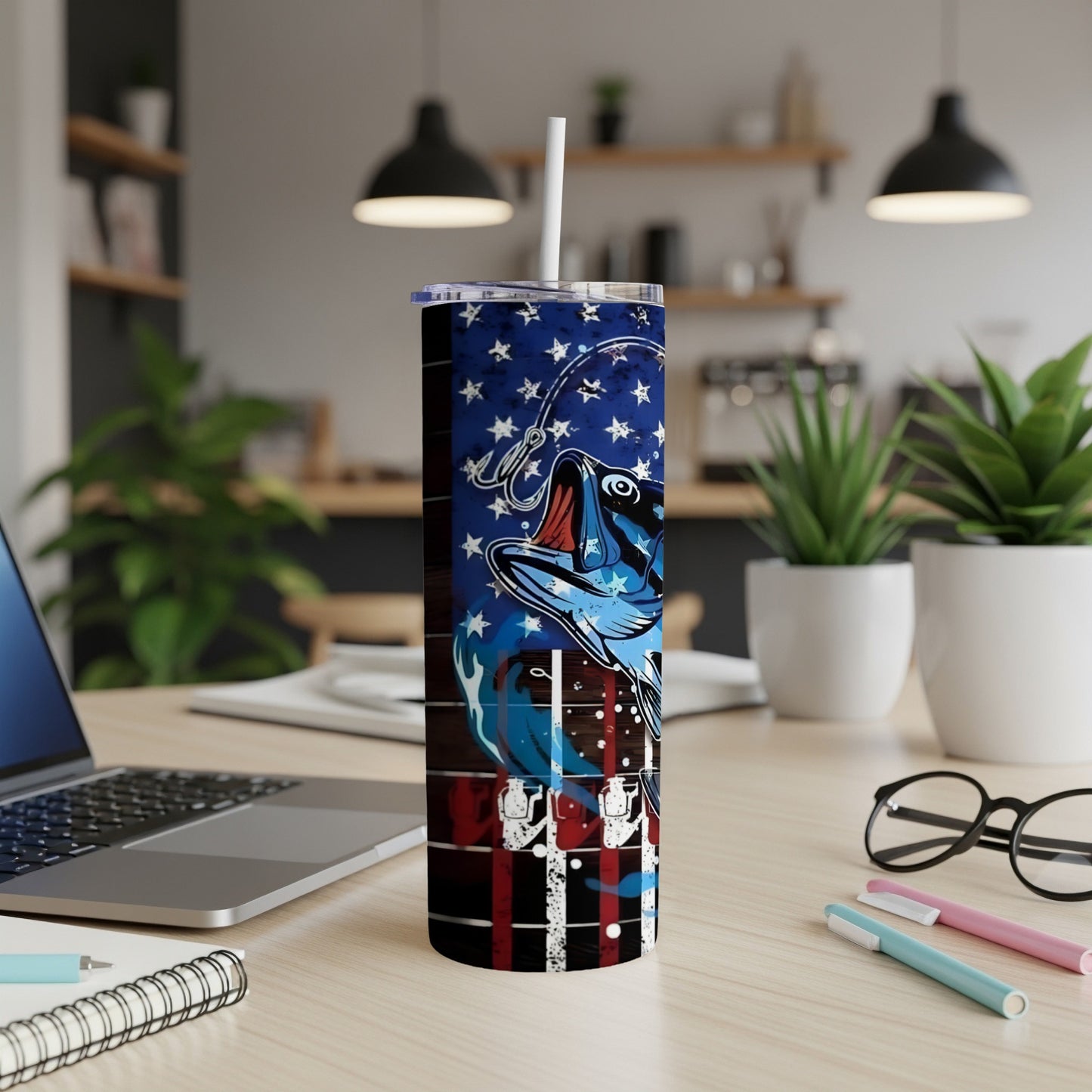American flag bass fishing tumbler with straw on desk.