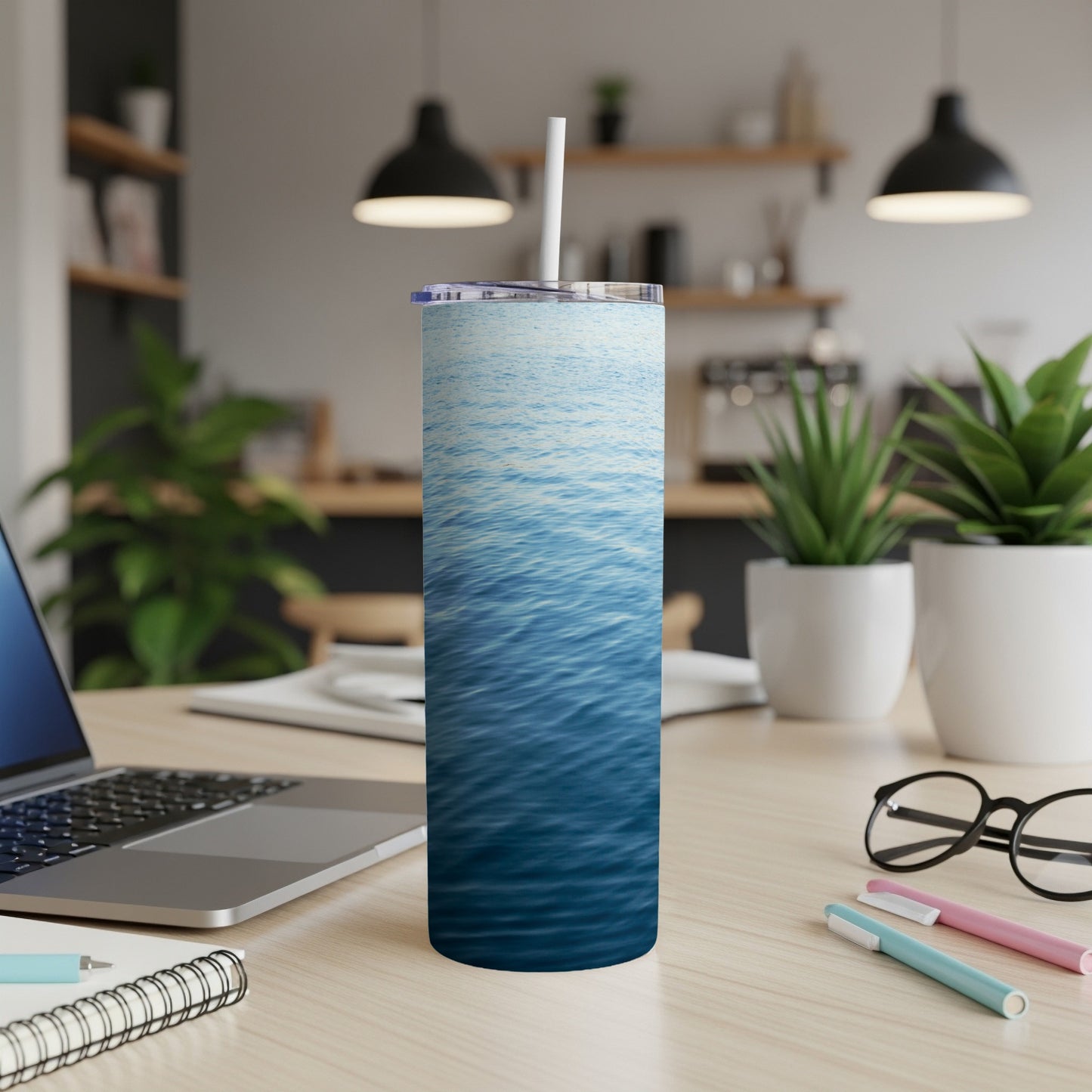 Blue water texture on a white tumbler with a straw.