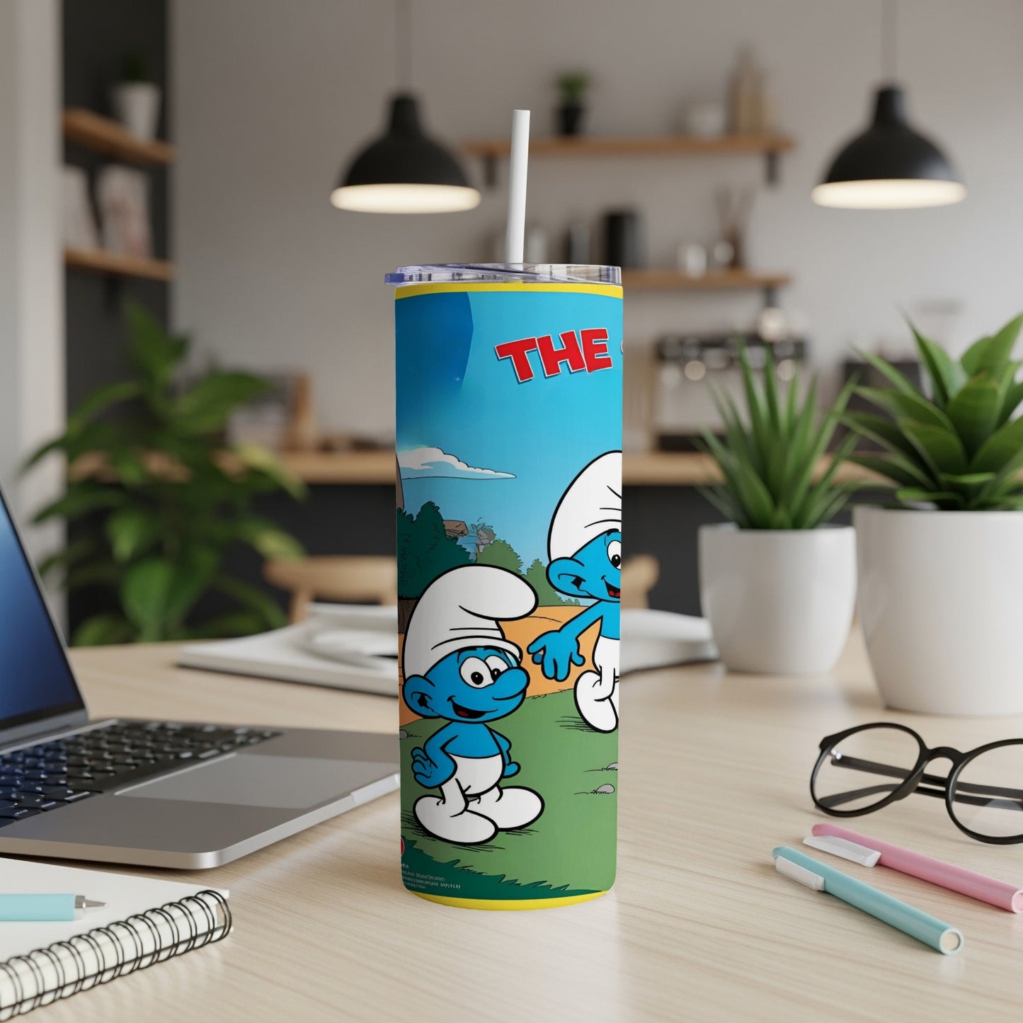 The Smurfs on a skinny tumbler with a straw.
